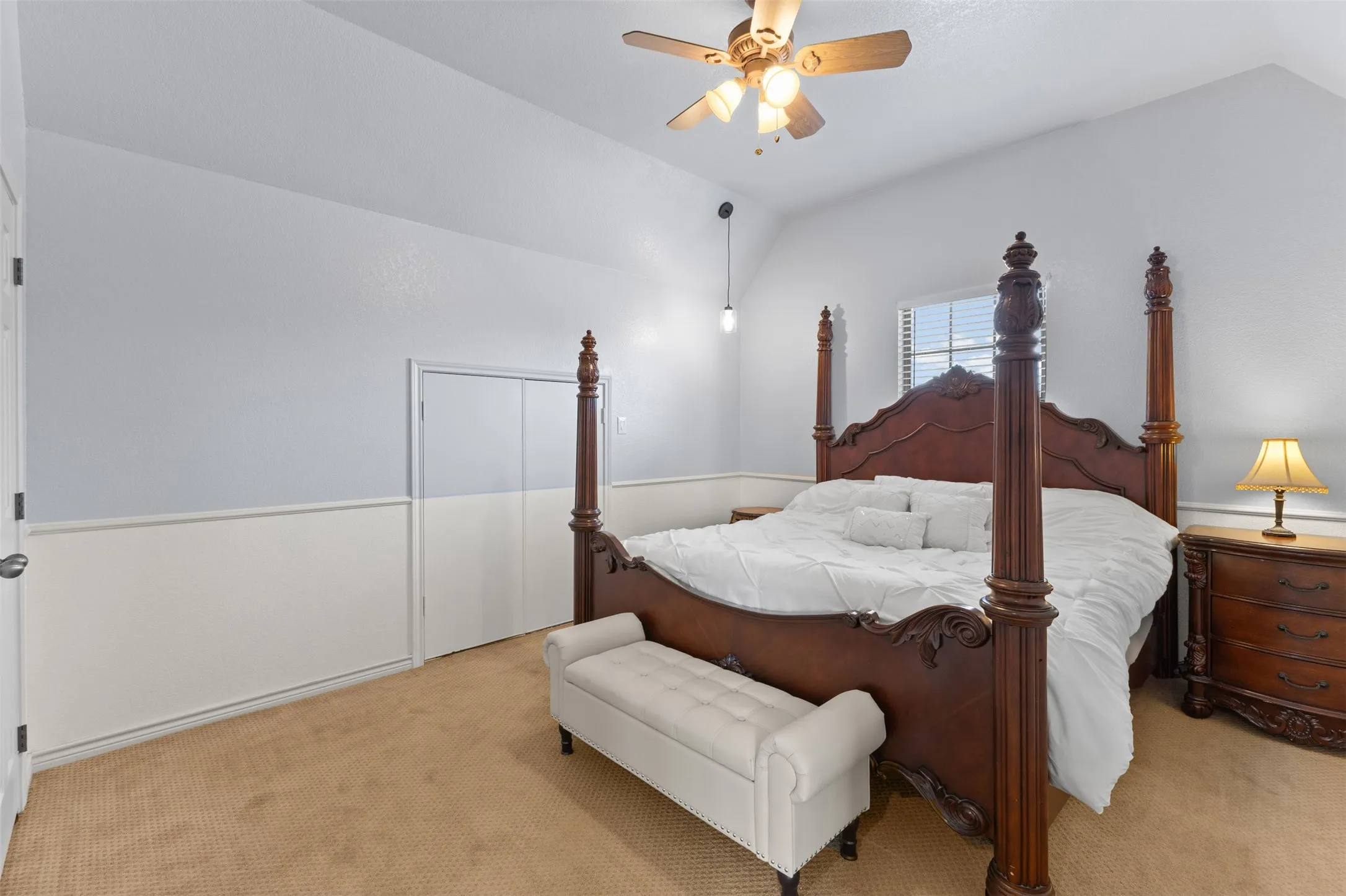 Upstairs primary suite with vaulted ceilings and a walk-in closet, added during the 2018 renovation for extra space and privacy.