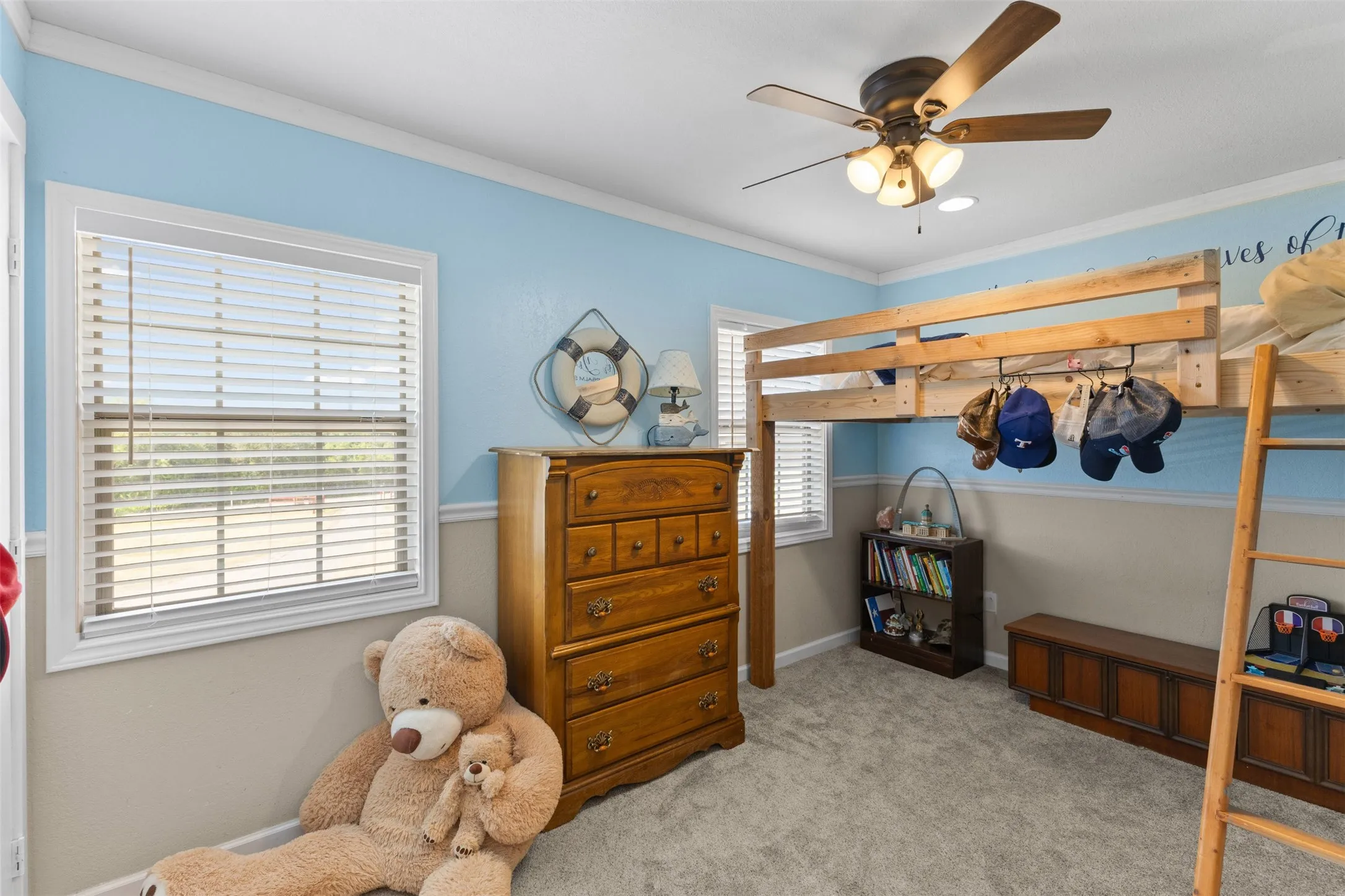 Carpeted flooring, white trim, and a ceiling fan with integrated lighting