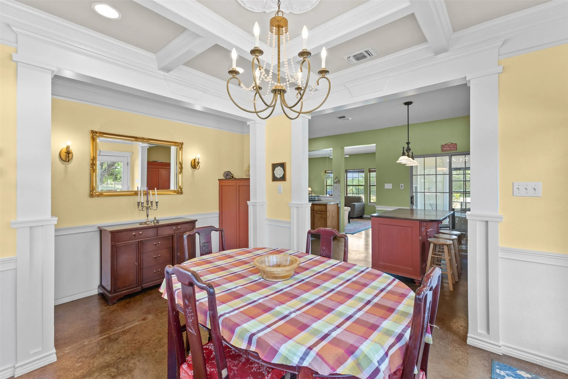 Coffered ceiling with recessed lighting and chandelier