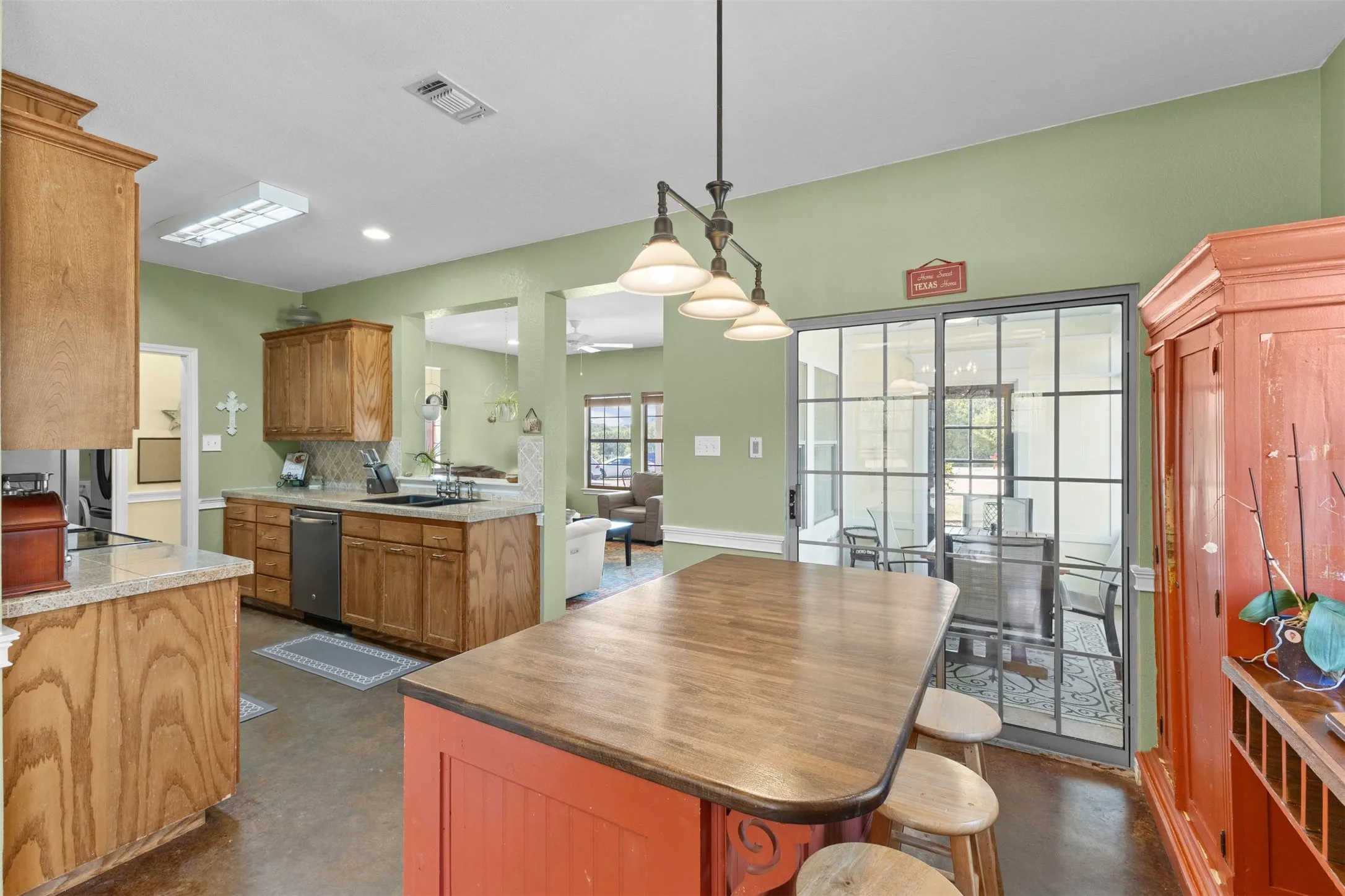 Kitchen featuring wood cabinetry, light-toned countertops, and a full suite of appliances