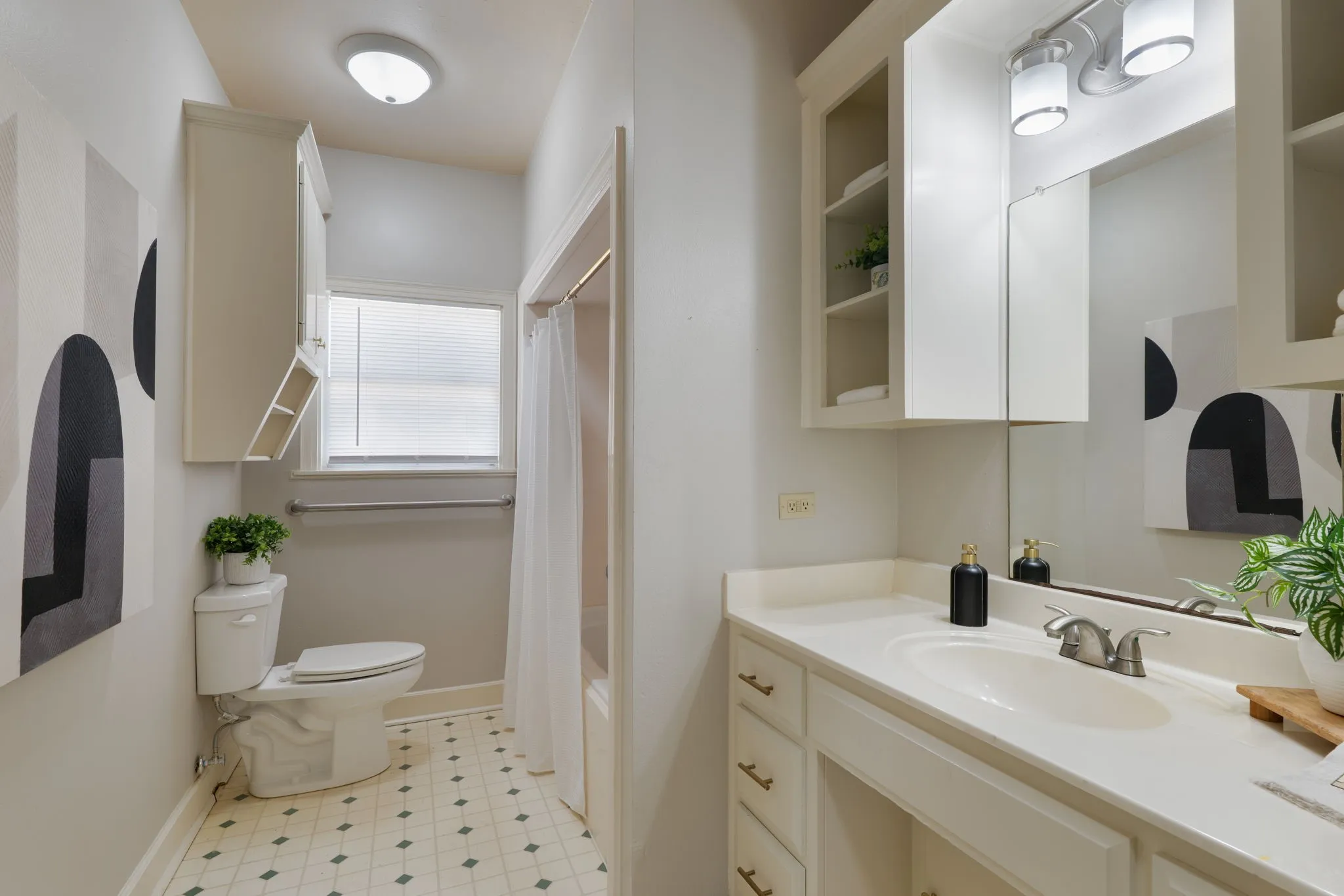 shared secondary bathroom; large built in vanity, upper shelves, updated fixtures for plumbing and lighting