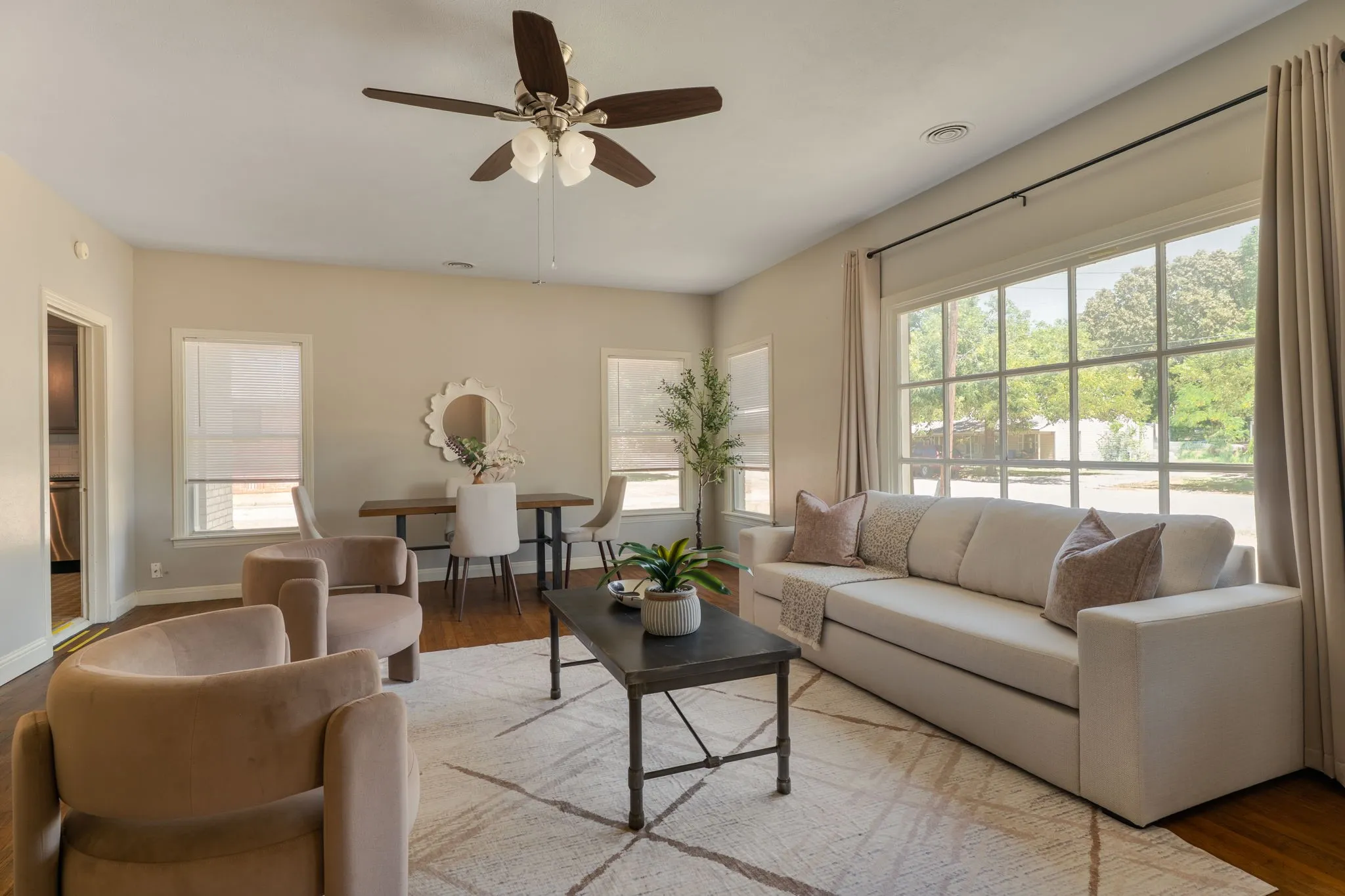 the sunlit living room and dining area