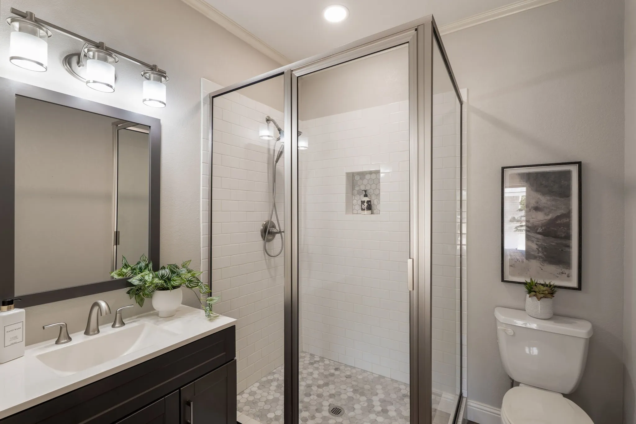 primary bathroom with tasteful updates and separate tiled shower