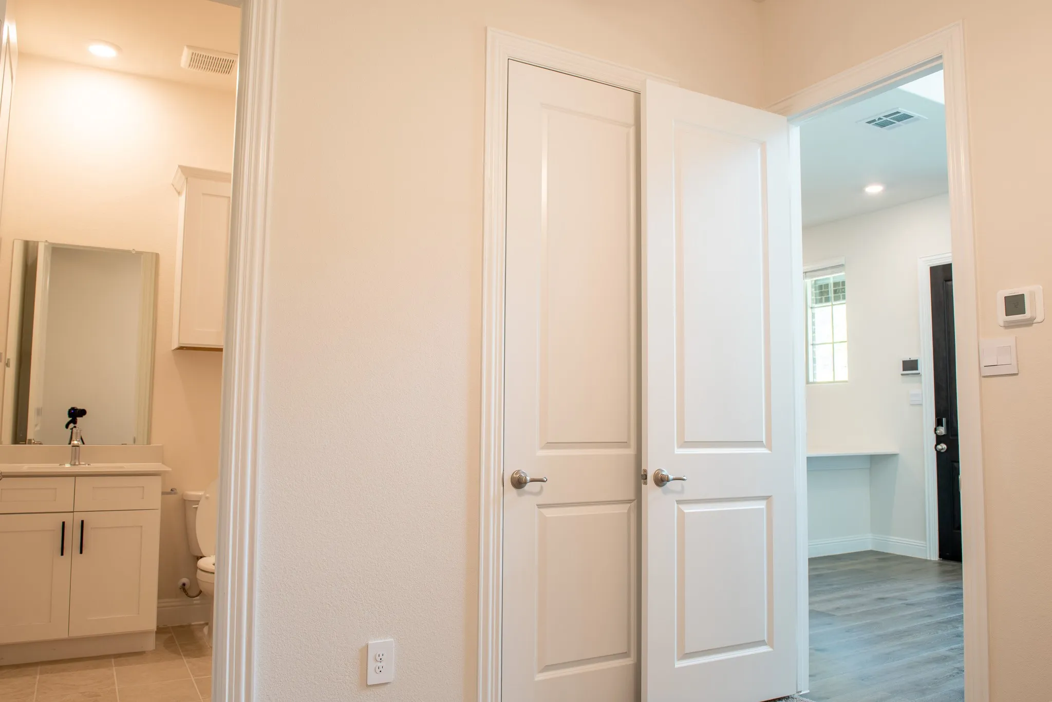 The downstairs third bedroom also includes an en-suite bath, ample closet space, and direct access to the living area for added convenience.
