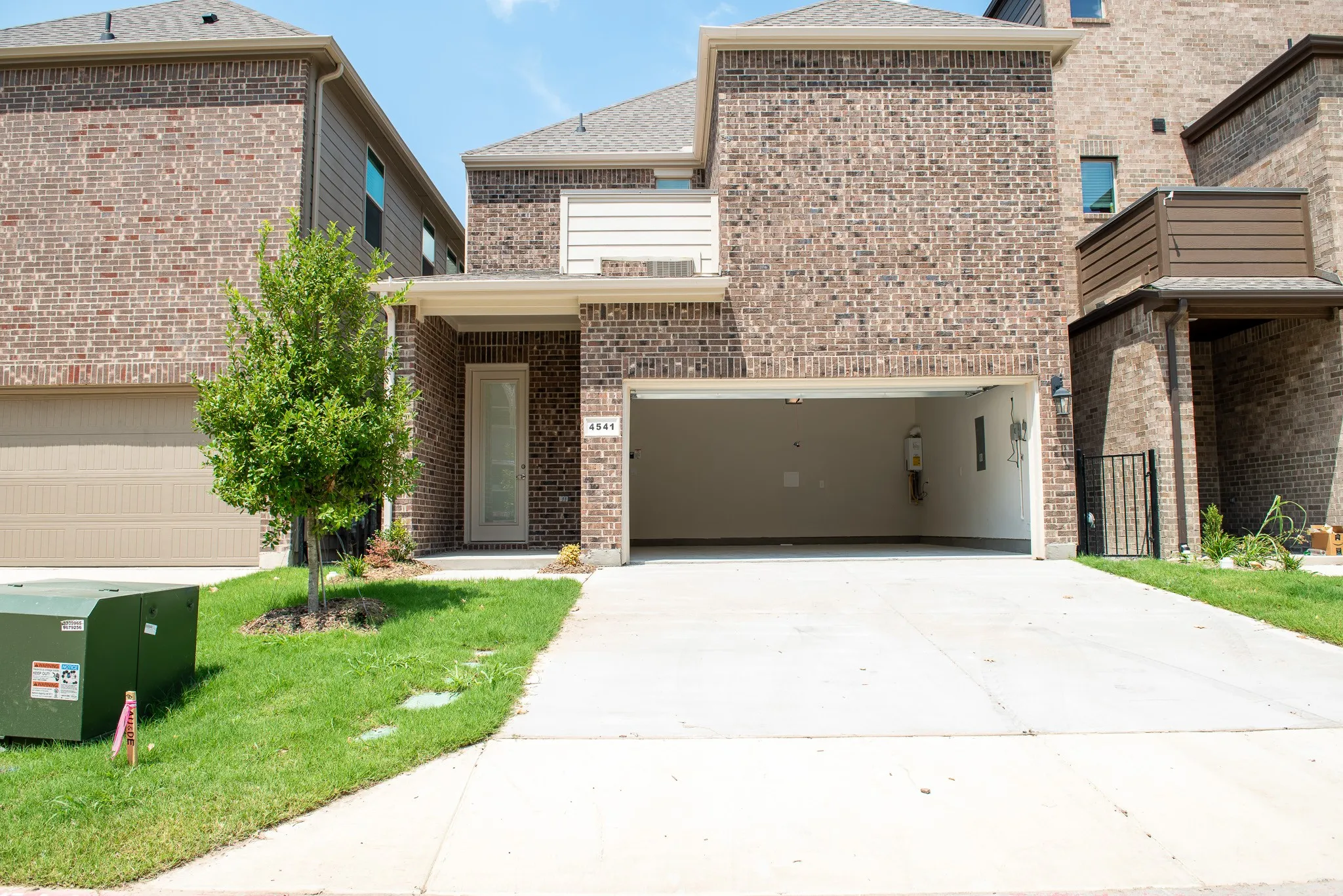 Rear-entry 2-car garage with additional driveway space for two more vehicles, offering both convenience and ample parking