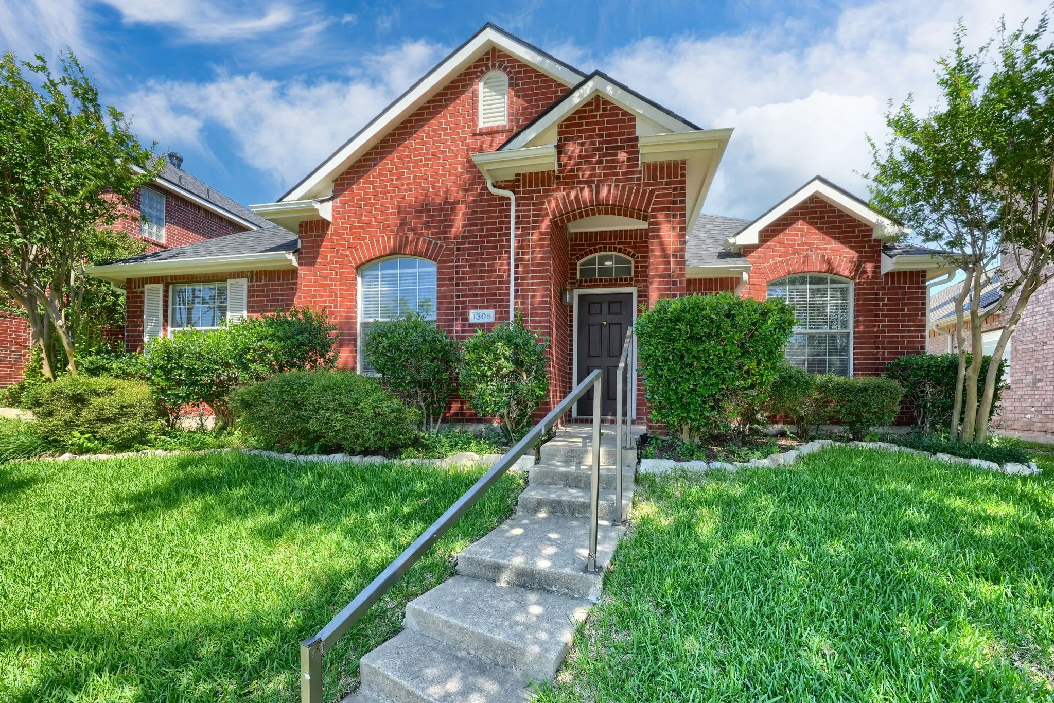 Red brick exterior with an arched entry