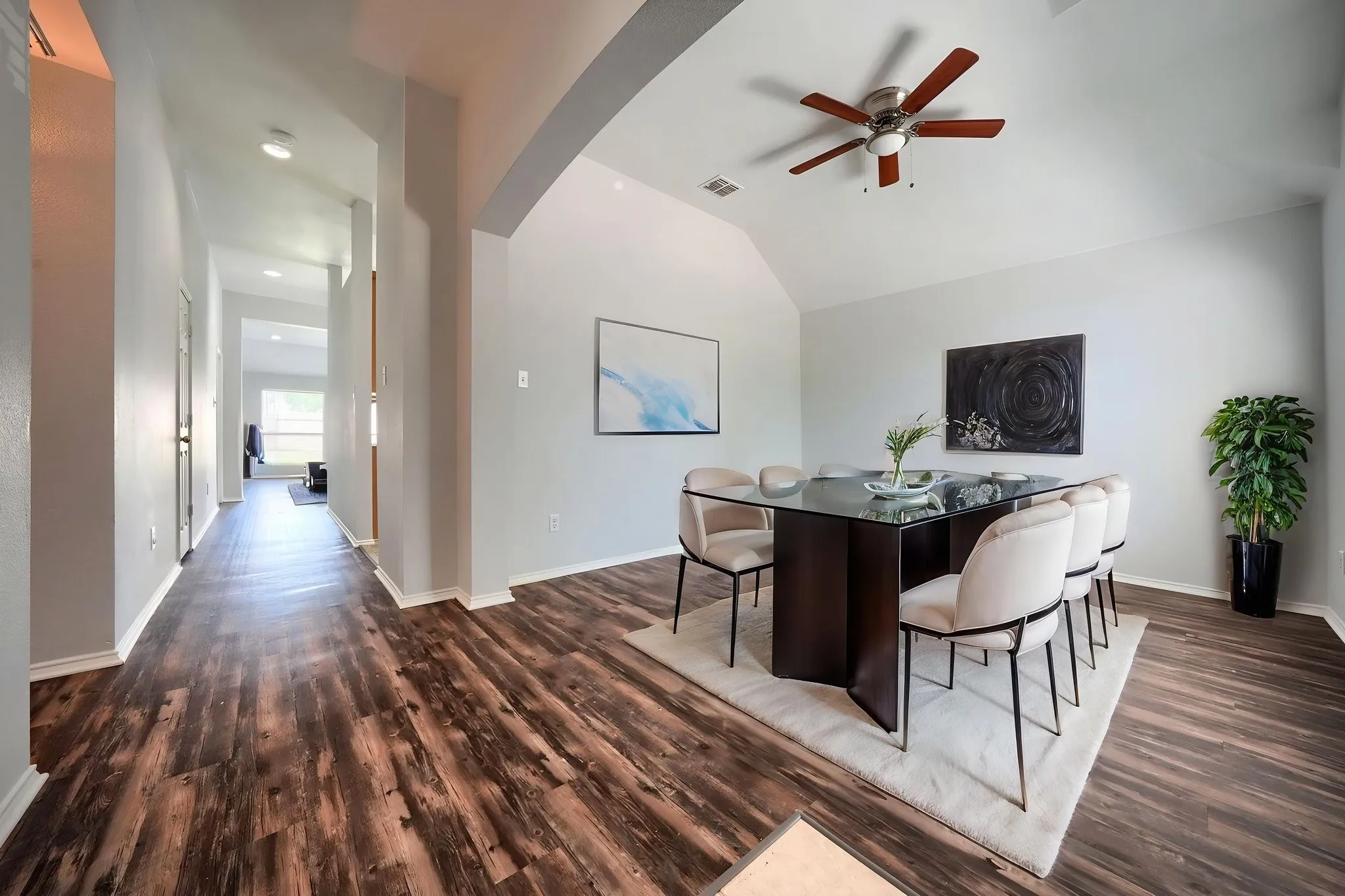 Vaulted ceiling with a ceiling fan, wood-finish flooring, and recessed lighting