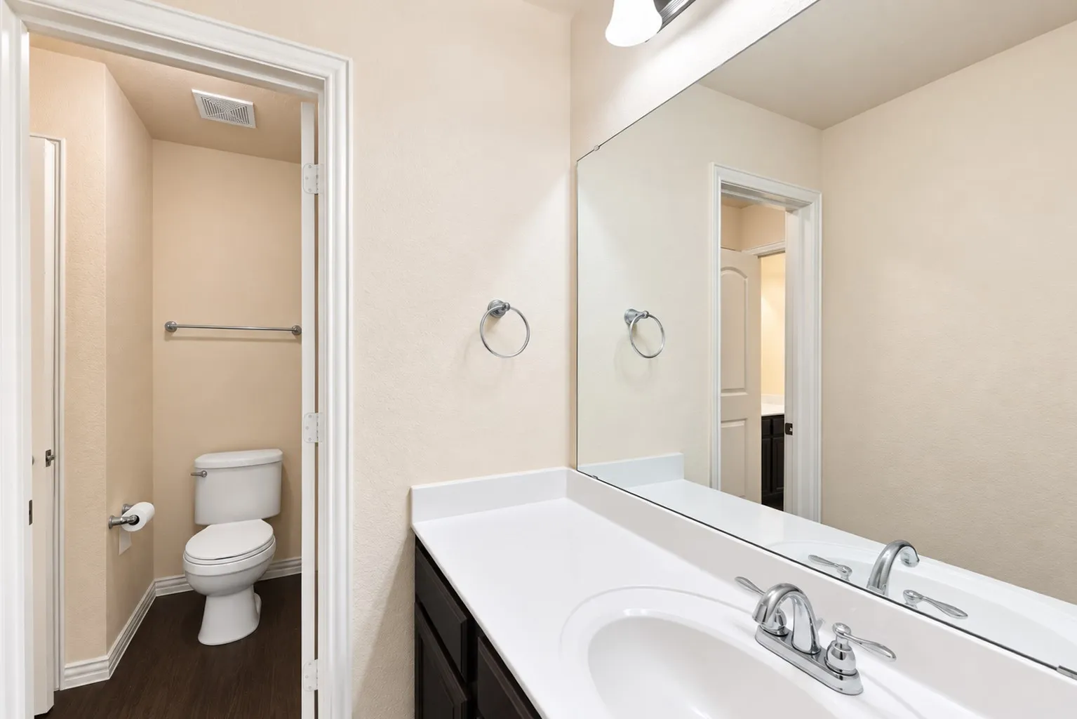 Vanity with white countertop, integrated sink, and chrome faucet