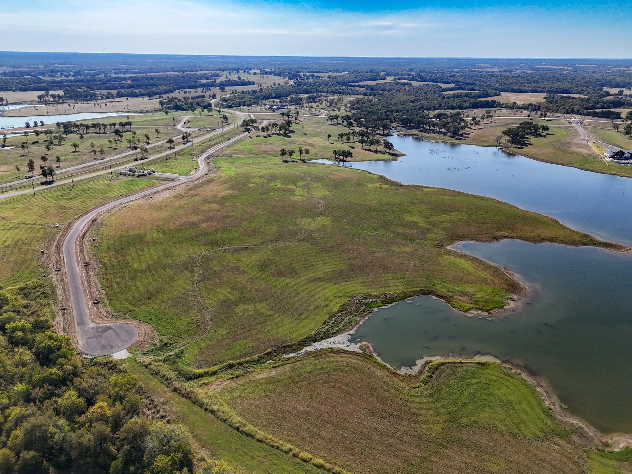 Aerial view of property and surrounding area with a large body of water