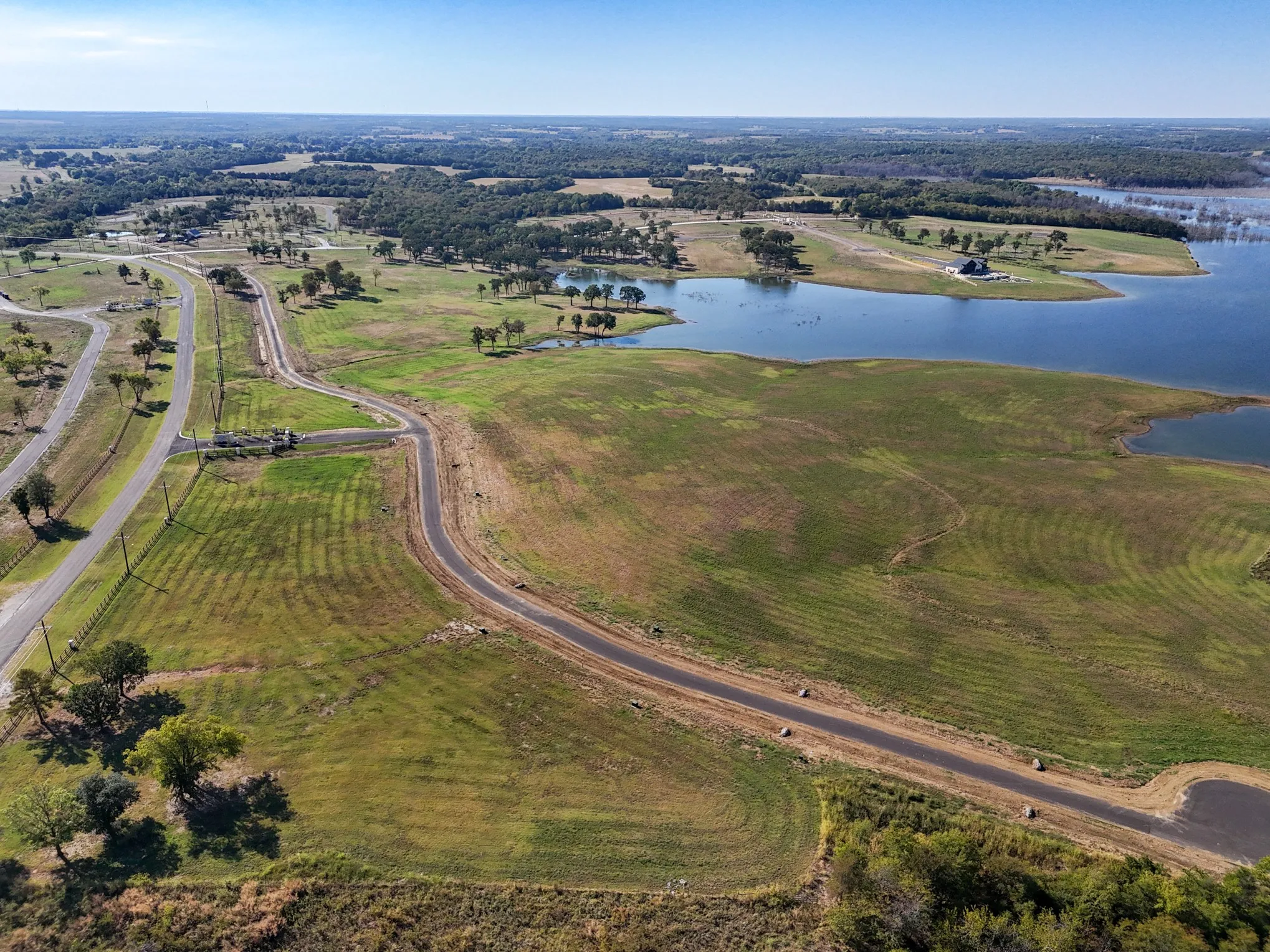 Aerial view of property and surrounding area with a nearby body of water
