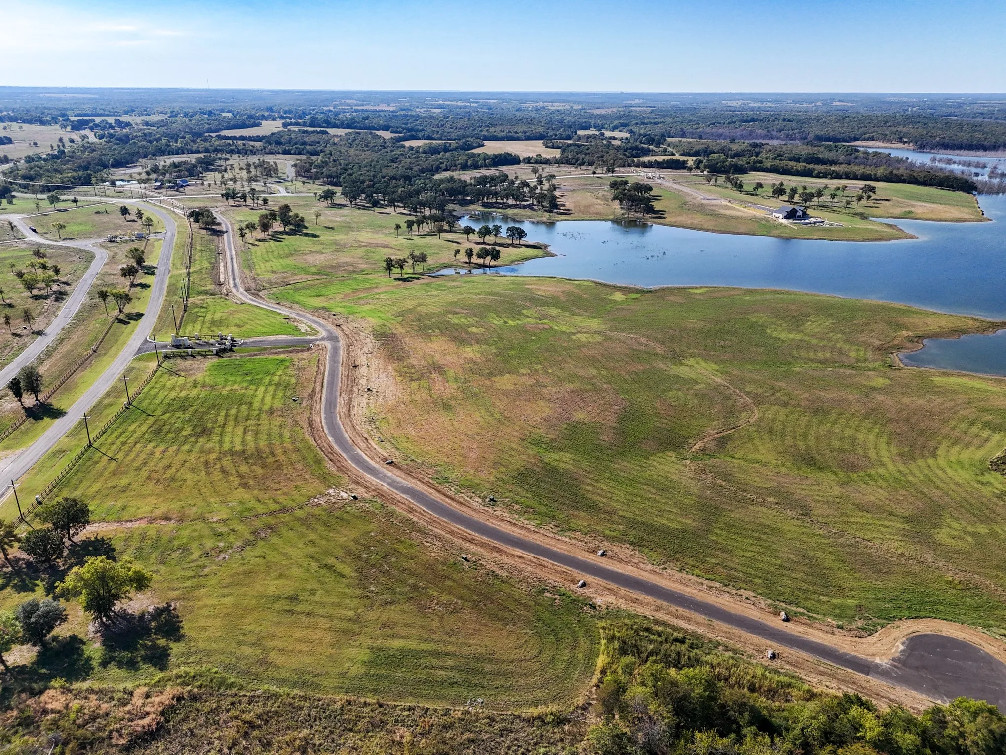 Aerial view of property and surrounding area with a large body of water