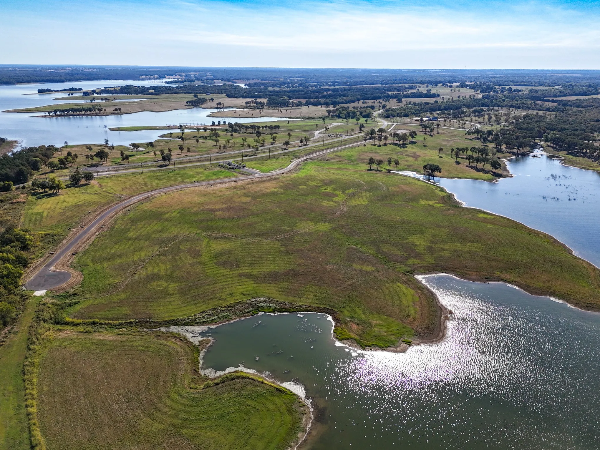 Aerial view of property and surrounding area with a large body of water