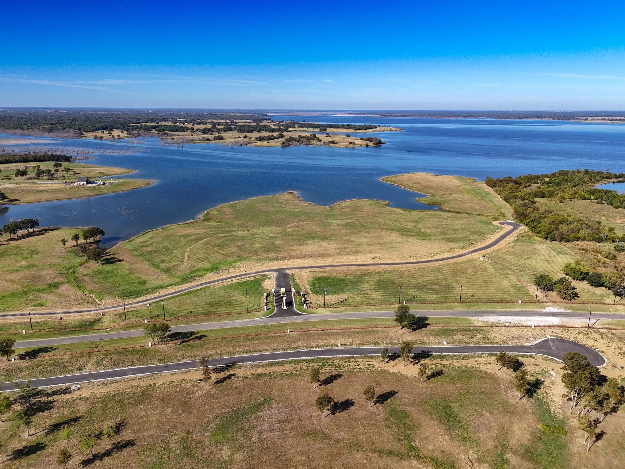 Aerial view of property and surrounding area featuring a large body of water