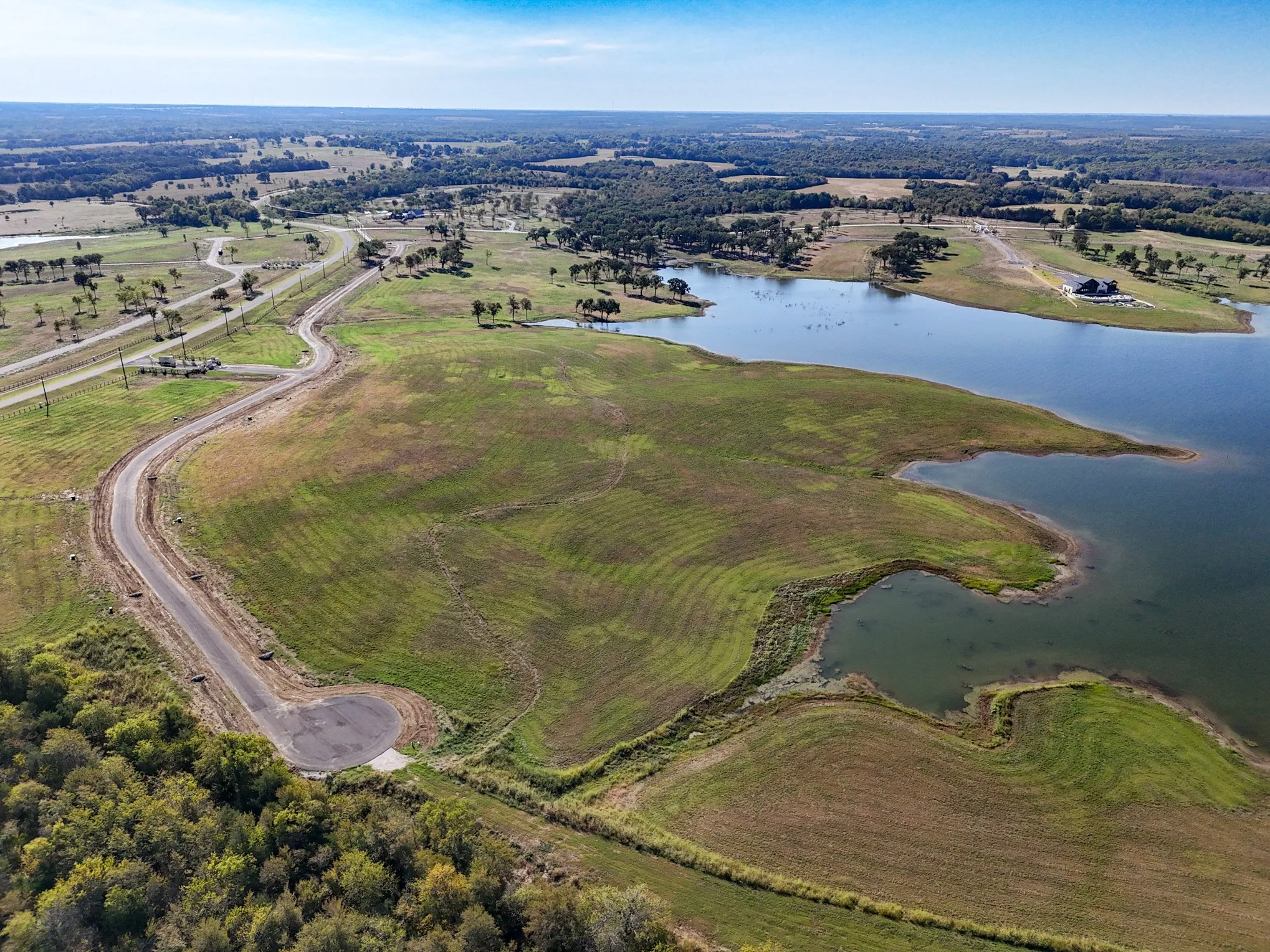 Aerial view of property and surrounding area featuring a large body of water