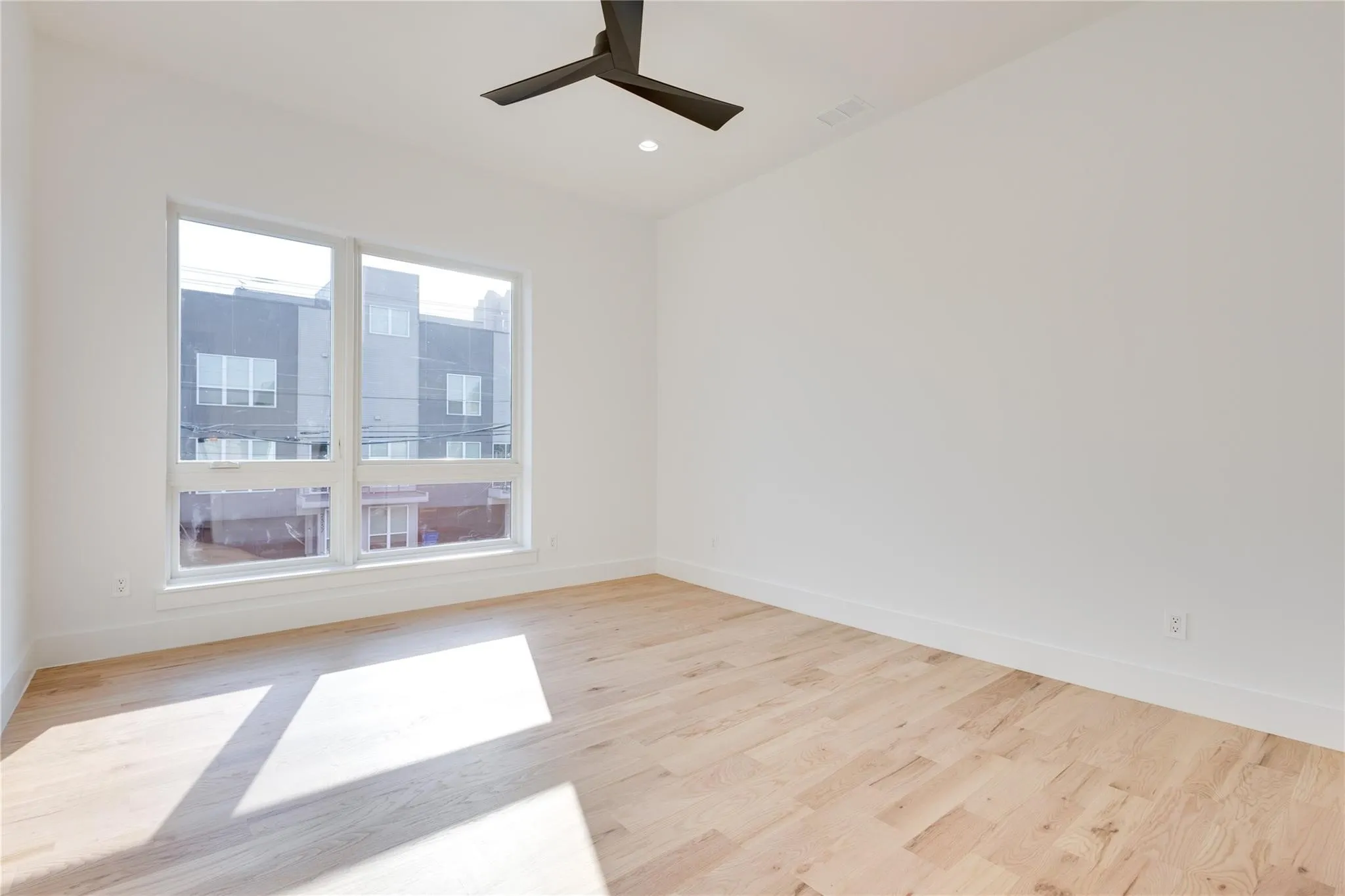 Empty room featuring light hardwood / wood-style flooring and ceiling fan