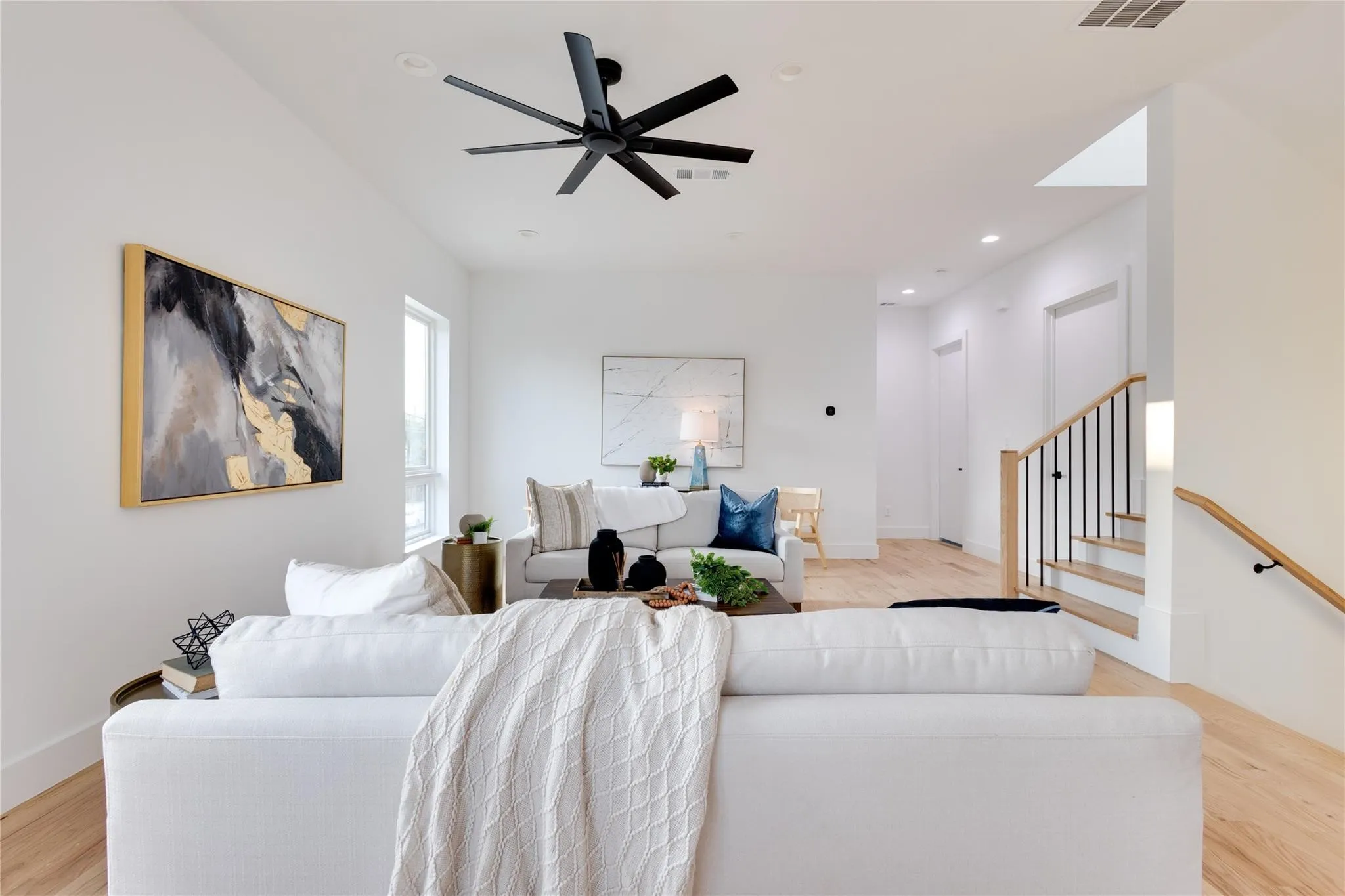 Living room featuring light hardwood / wood-style flooring and ceiling fan