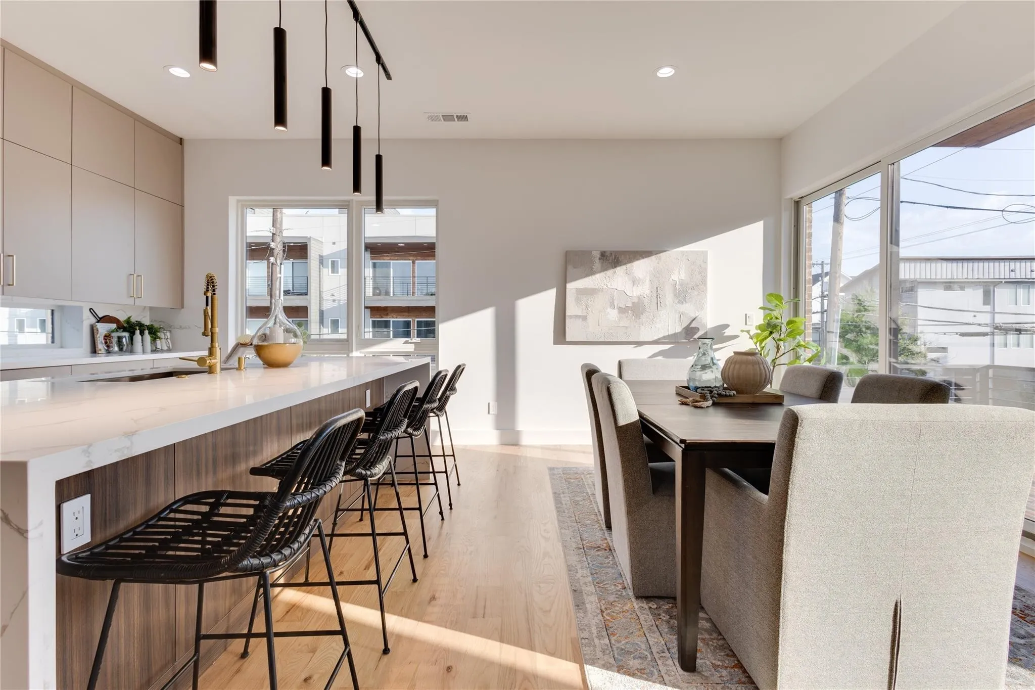 Kitchen featuring a kitchen breakfast bar, gray cabinets, hanging light fixtures, and light hardwood / wood-style flooring