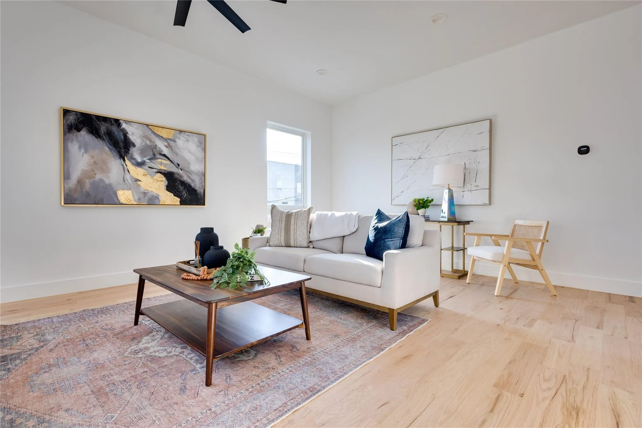 Living room featuring ceiling fan and light wood-type flooring