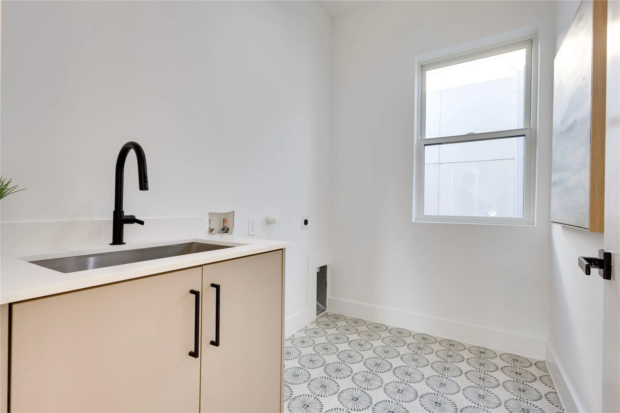 Laundry room featuring electric dryer hookup, sink, washer hookup, and cabinets