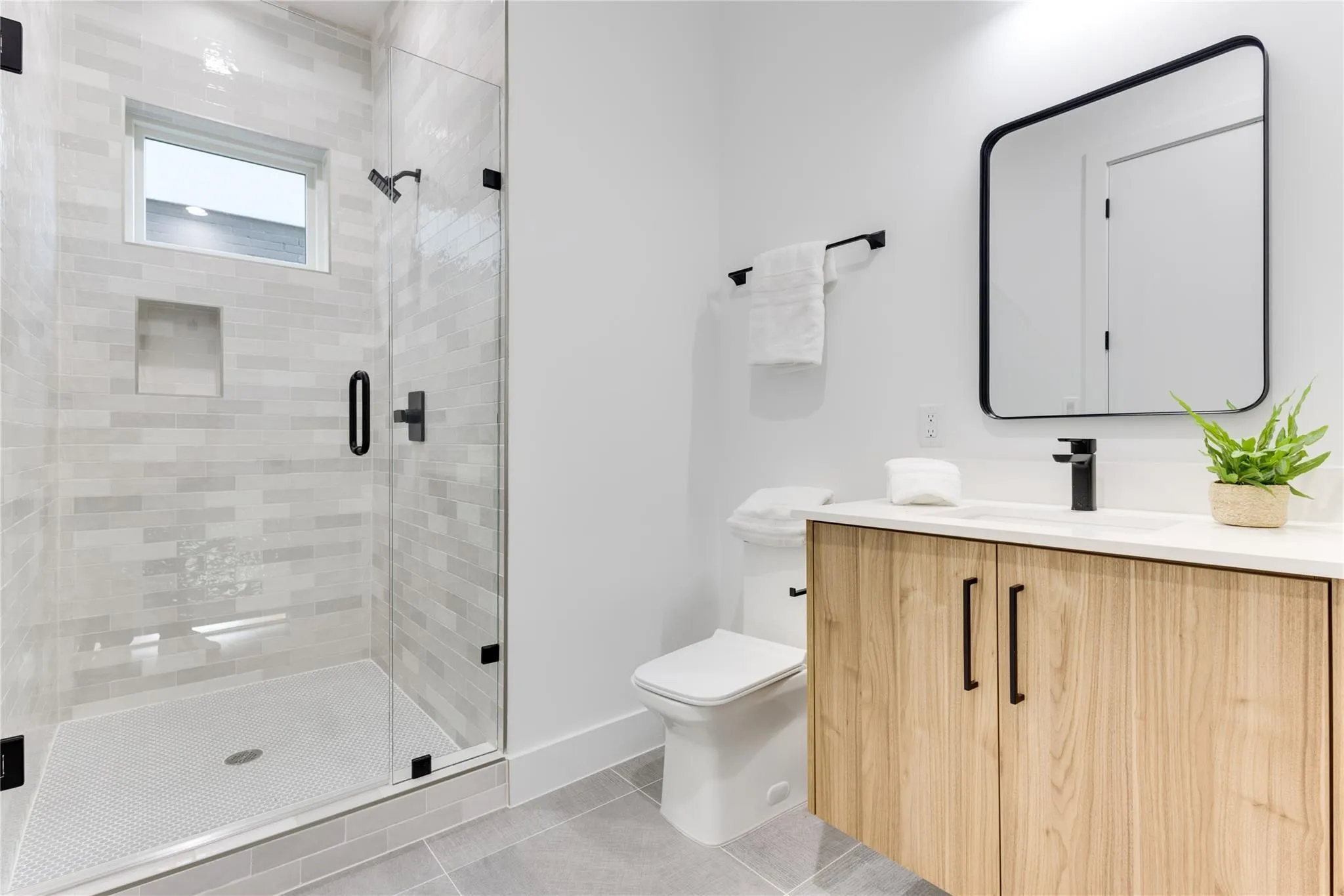 Bathroom featuring vanity, an enclosed shower, tile patterned floors, and toilet