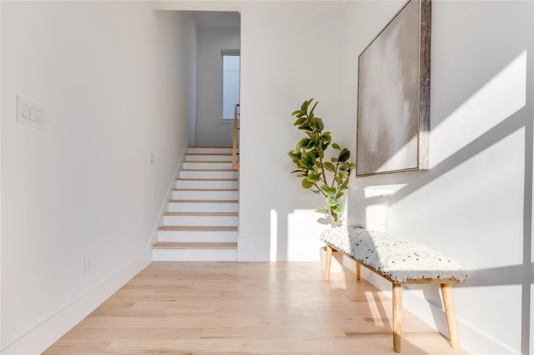 Staircase with hardwood / wood-style flooring