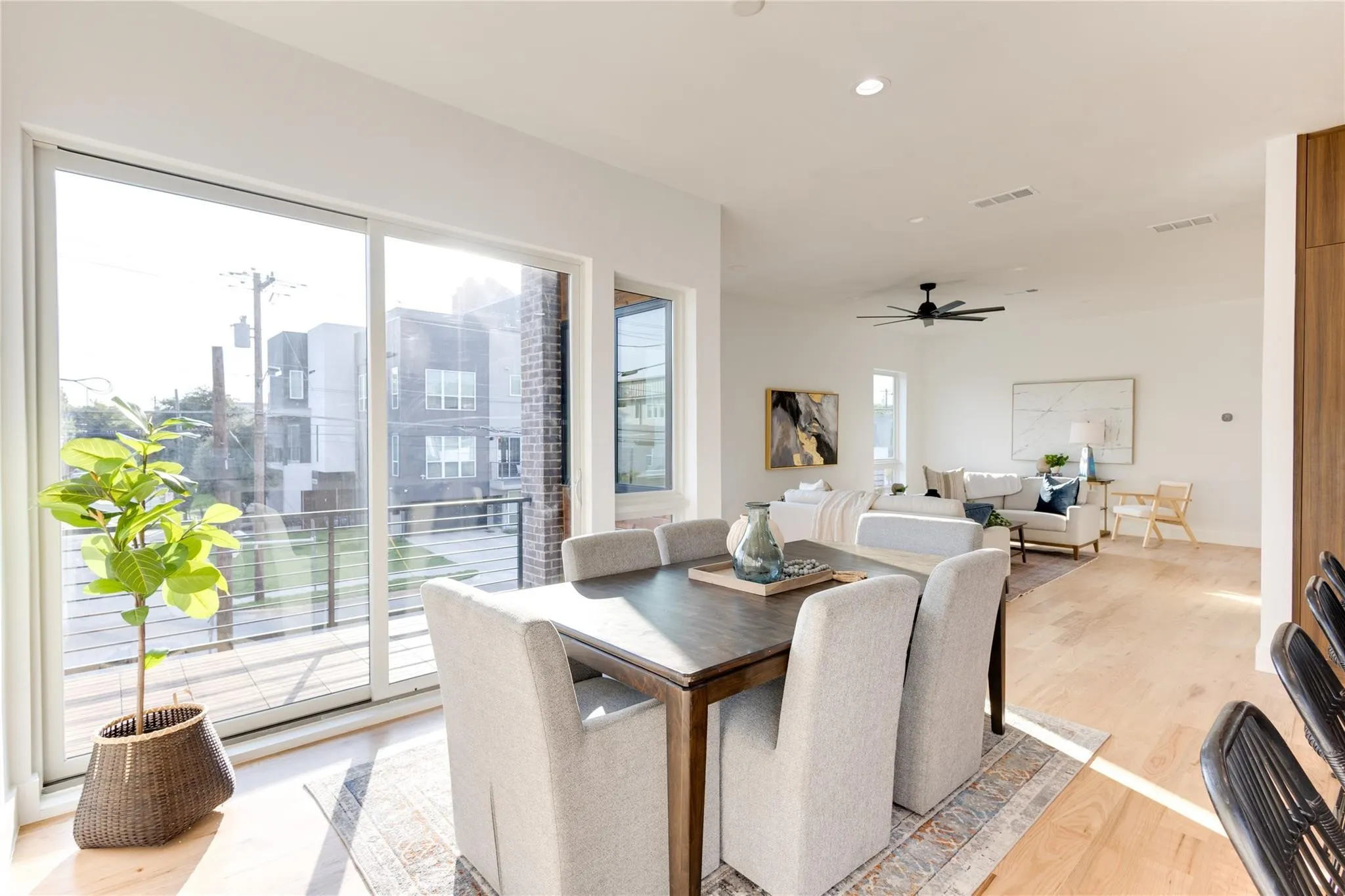 Dining space with ceiling fan and light wood-type flooring