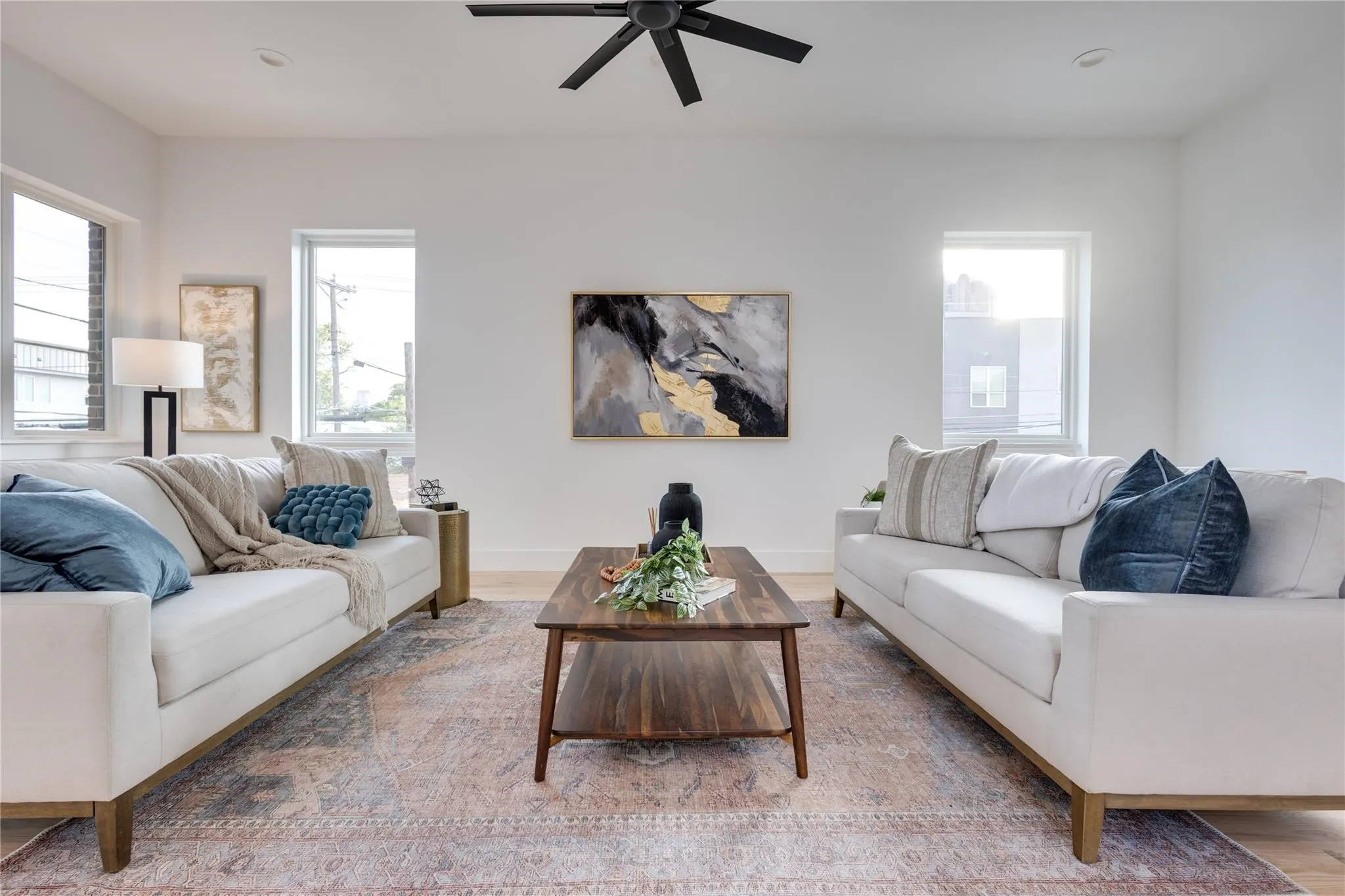 Living room with hardwood / wood-style flooring and ceiling fan