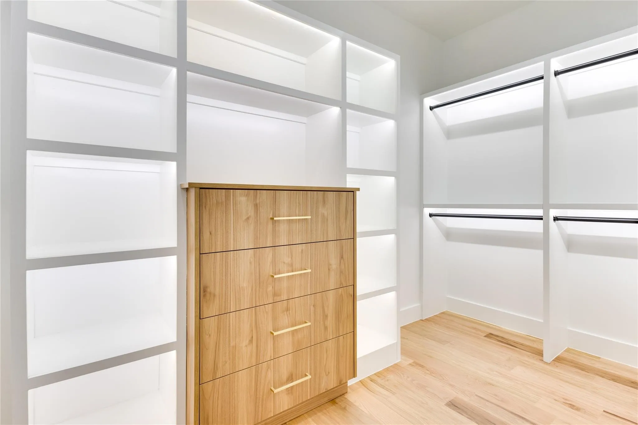 Spacious closet featuring hardwood / wood-style floors