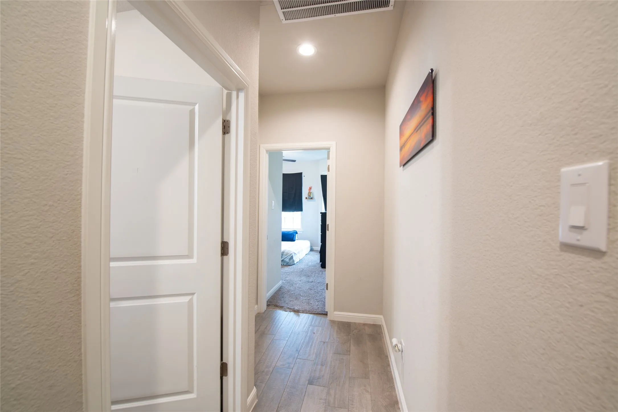 Wood-finish flooring throughout the hallway