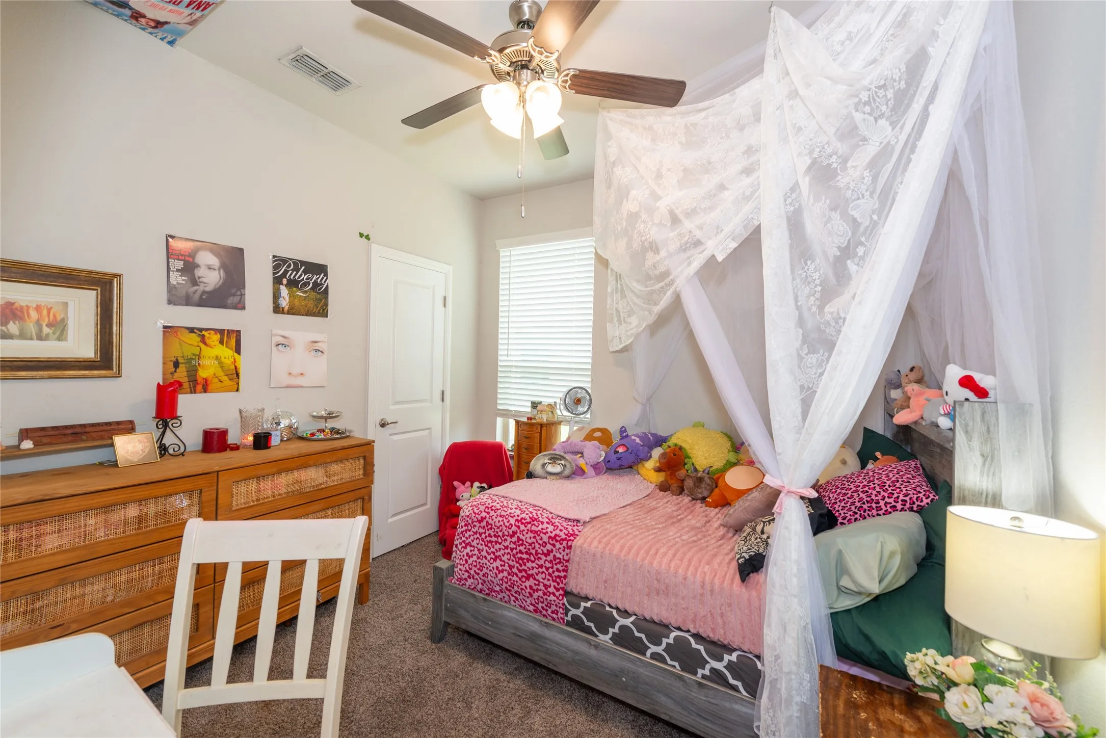 Vaulted ceiling with a ceiling fan, window with blinds, and light gray wall paint