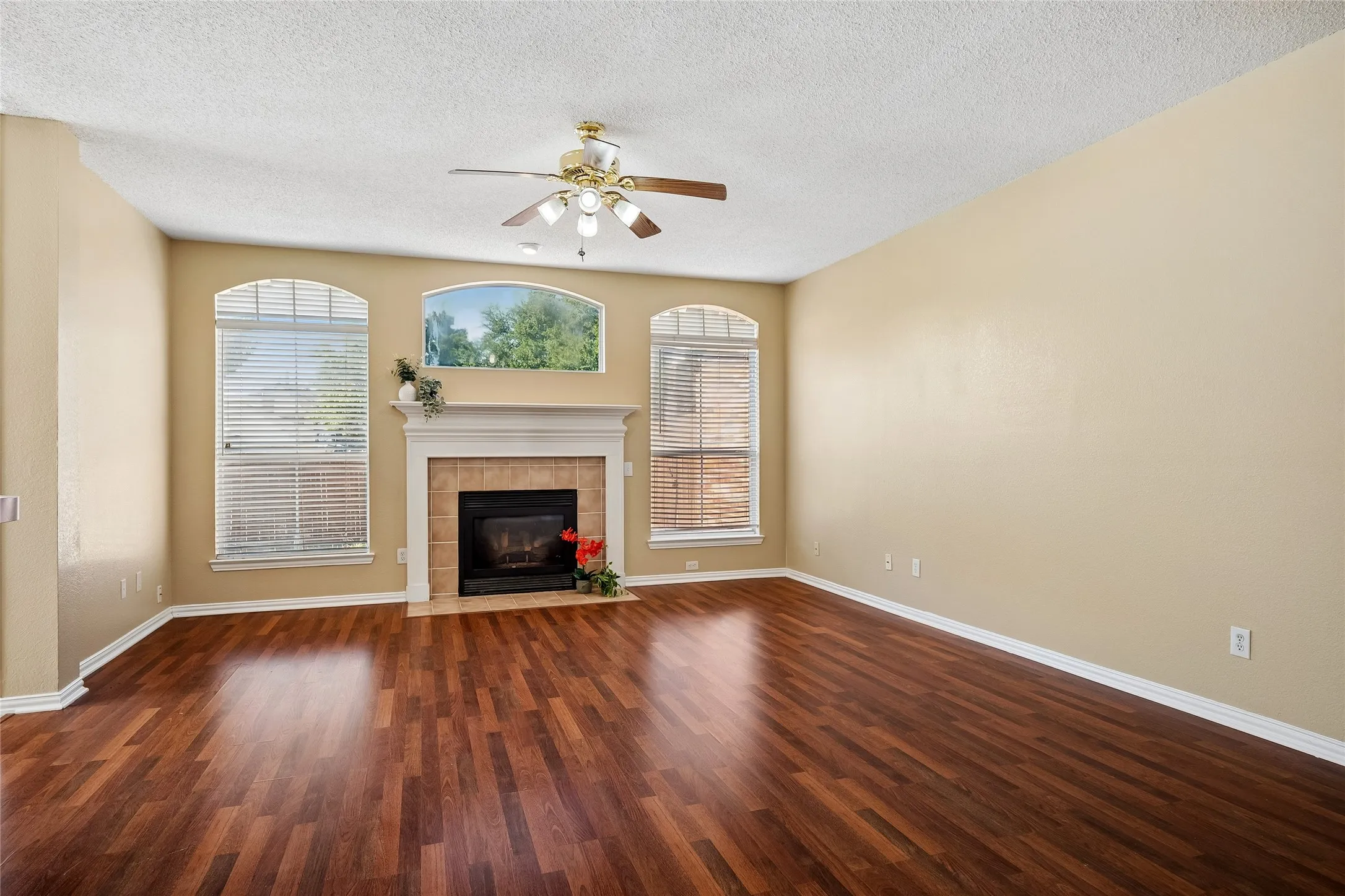 Family Room with center Fireplace and handsome flooring