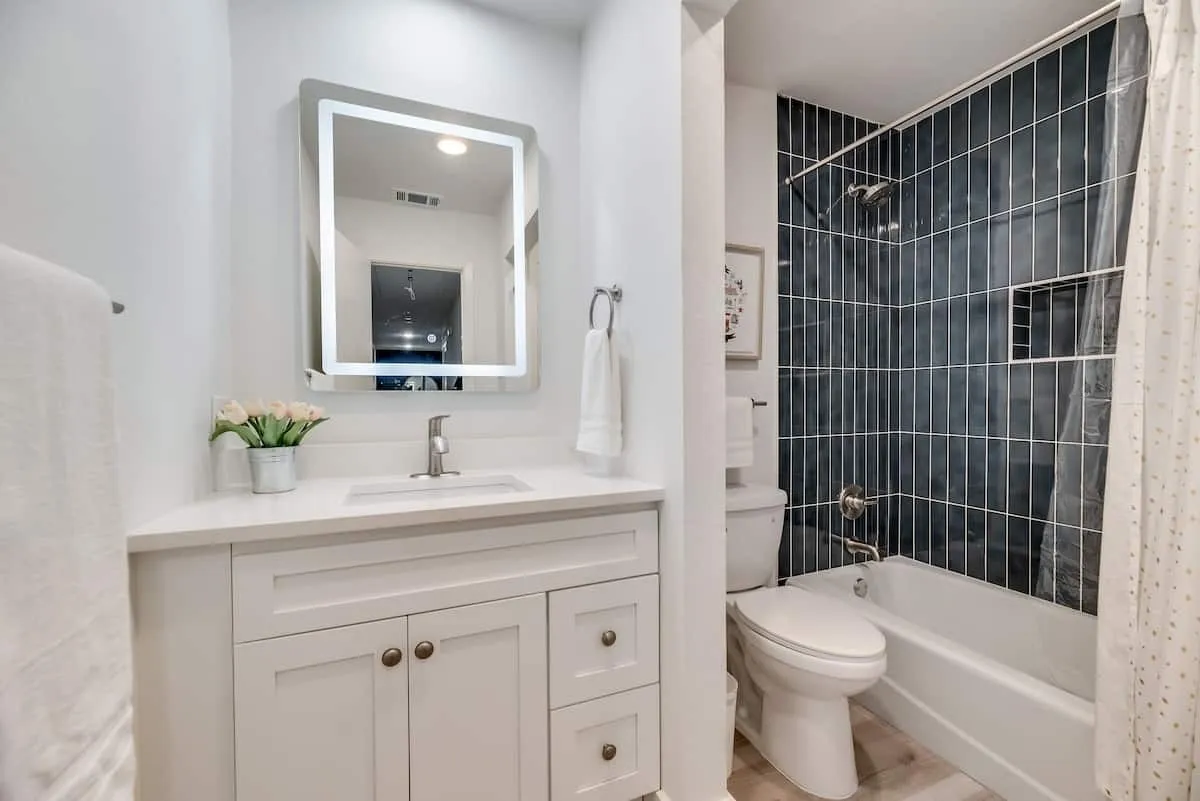 Shared hall bathroom with tub and shower.