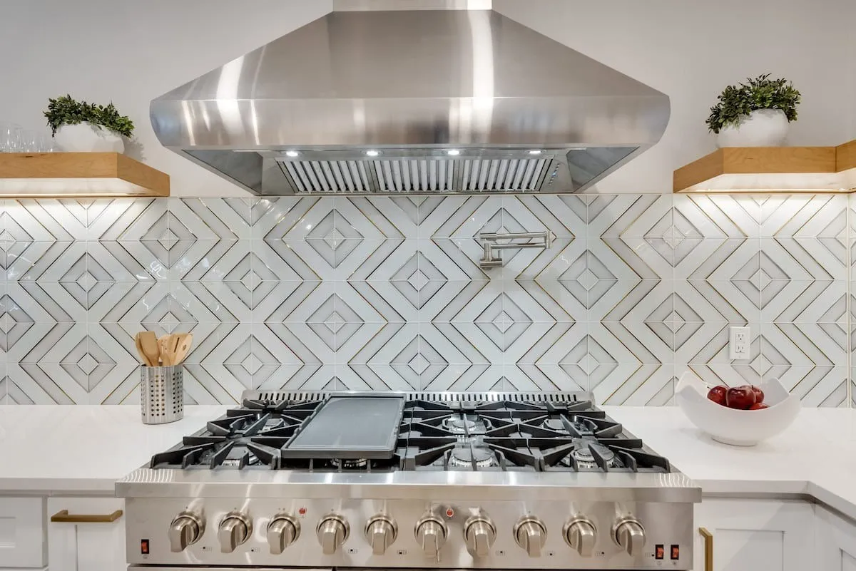 Stainless steel 8 burner gas range paired with a robust range hood!