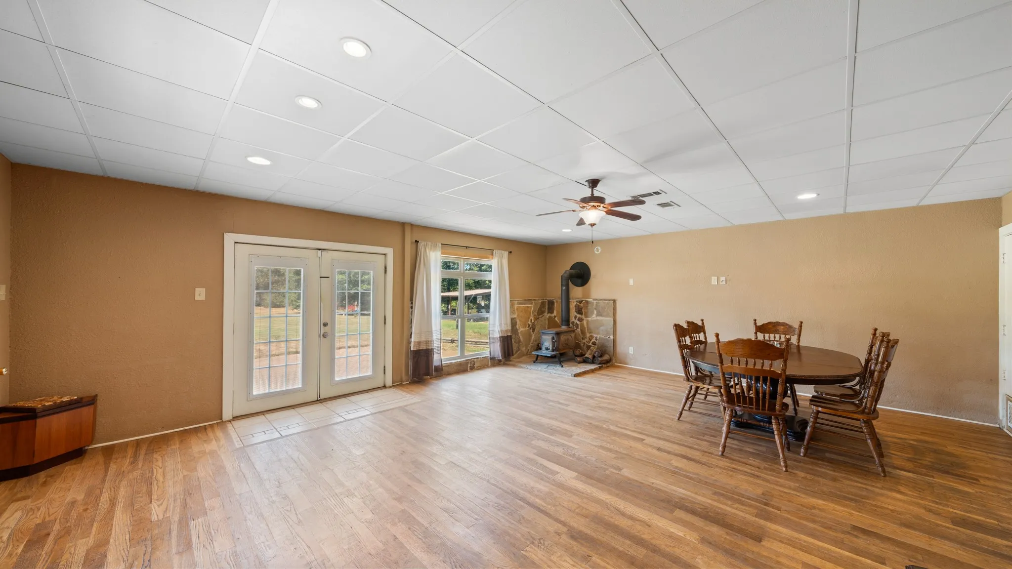 Wood-finish flooring throughout, recessed lighting, and a ceiling fan