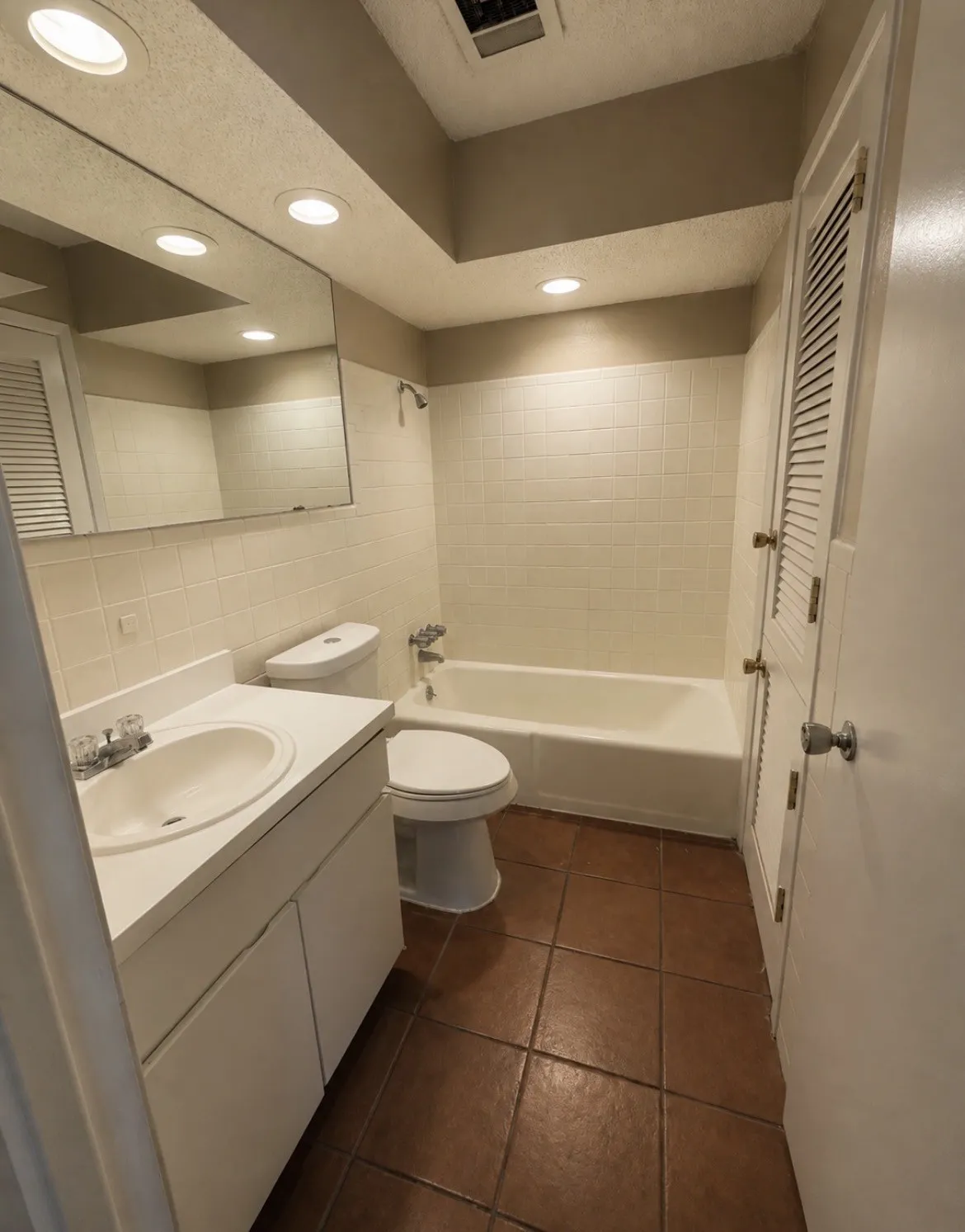 Bathroom-upstairs featuring a white vanity with integrated sink, white tiled shower and bathtub combination, ceramic tile flooring, and recessed lighting
