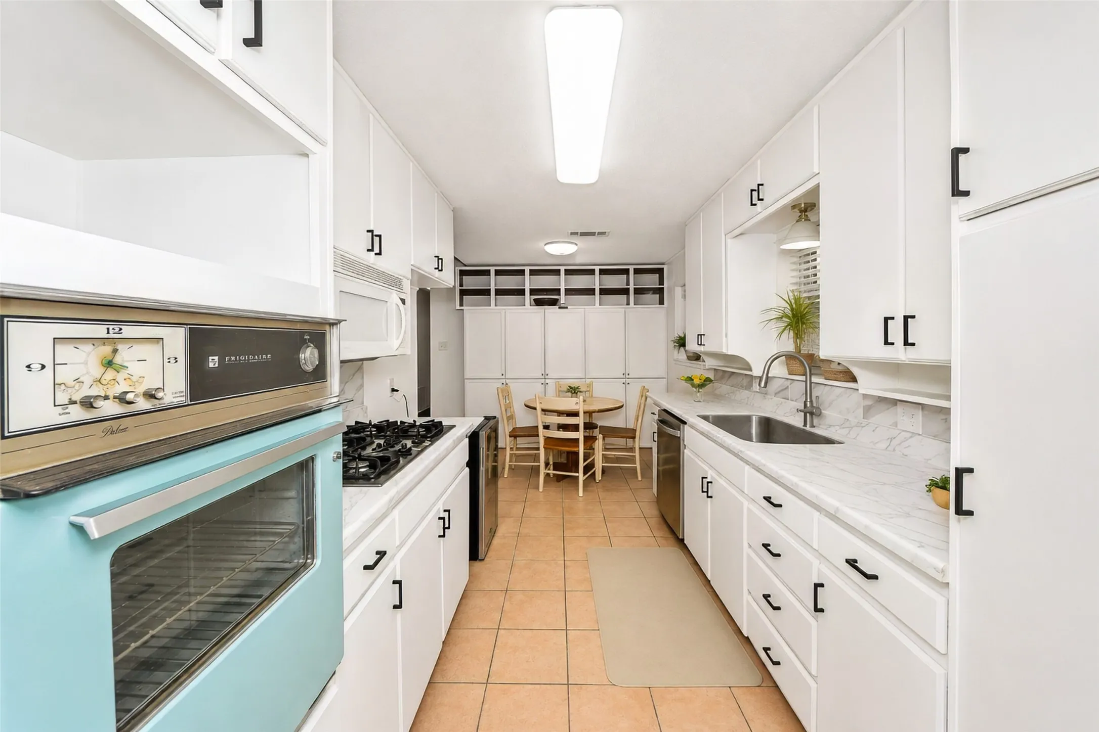 From the kitchen with the dining room behind, looking to the breakfast nook ahead.