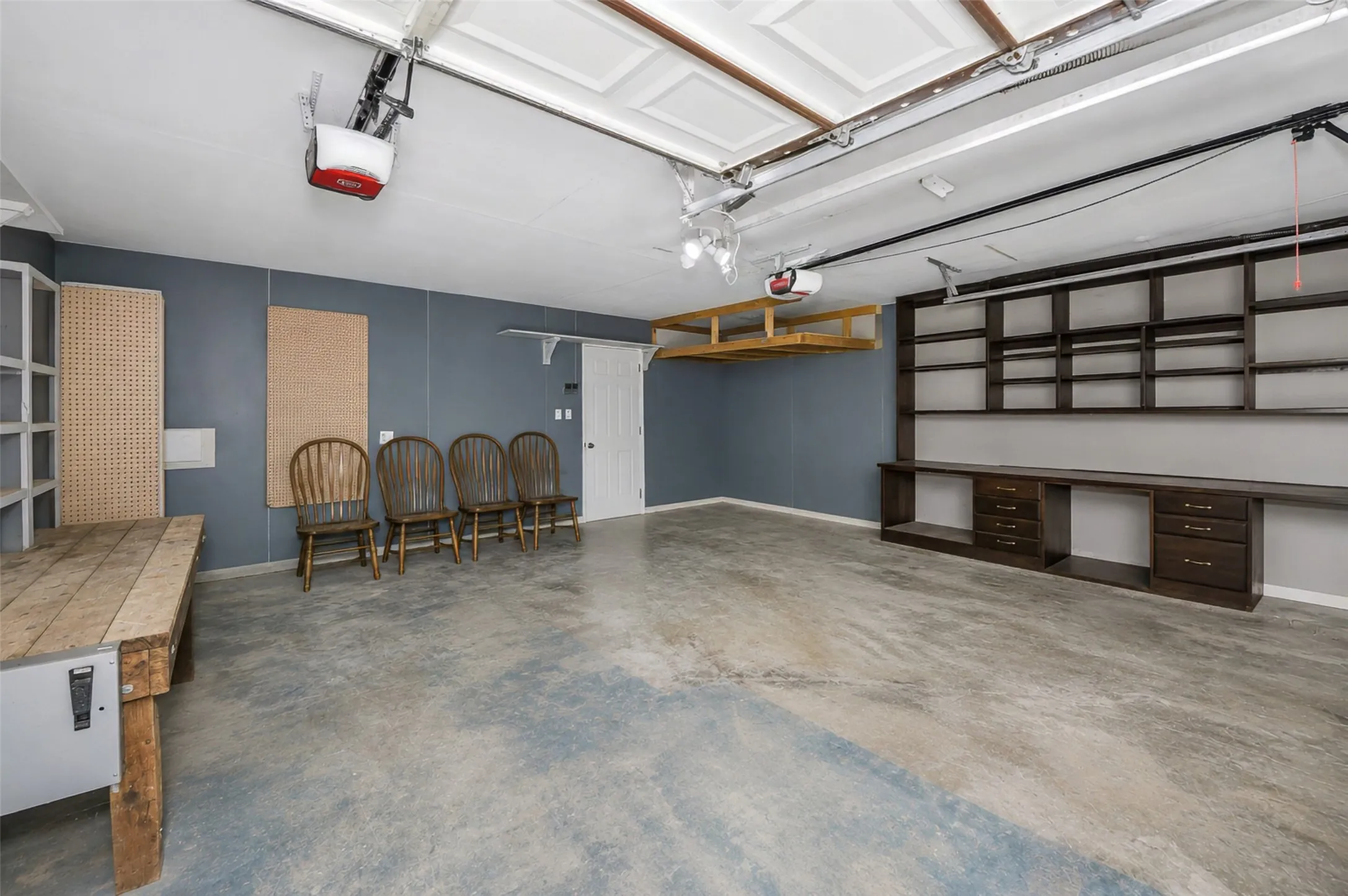 Garage with work benches and shelves