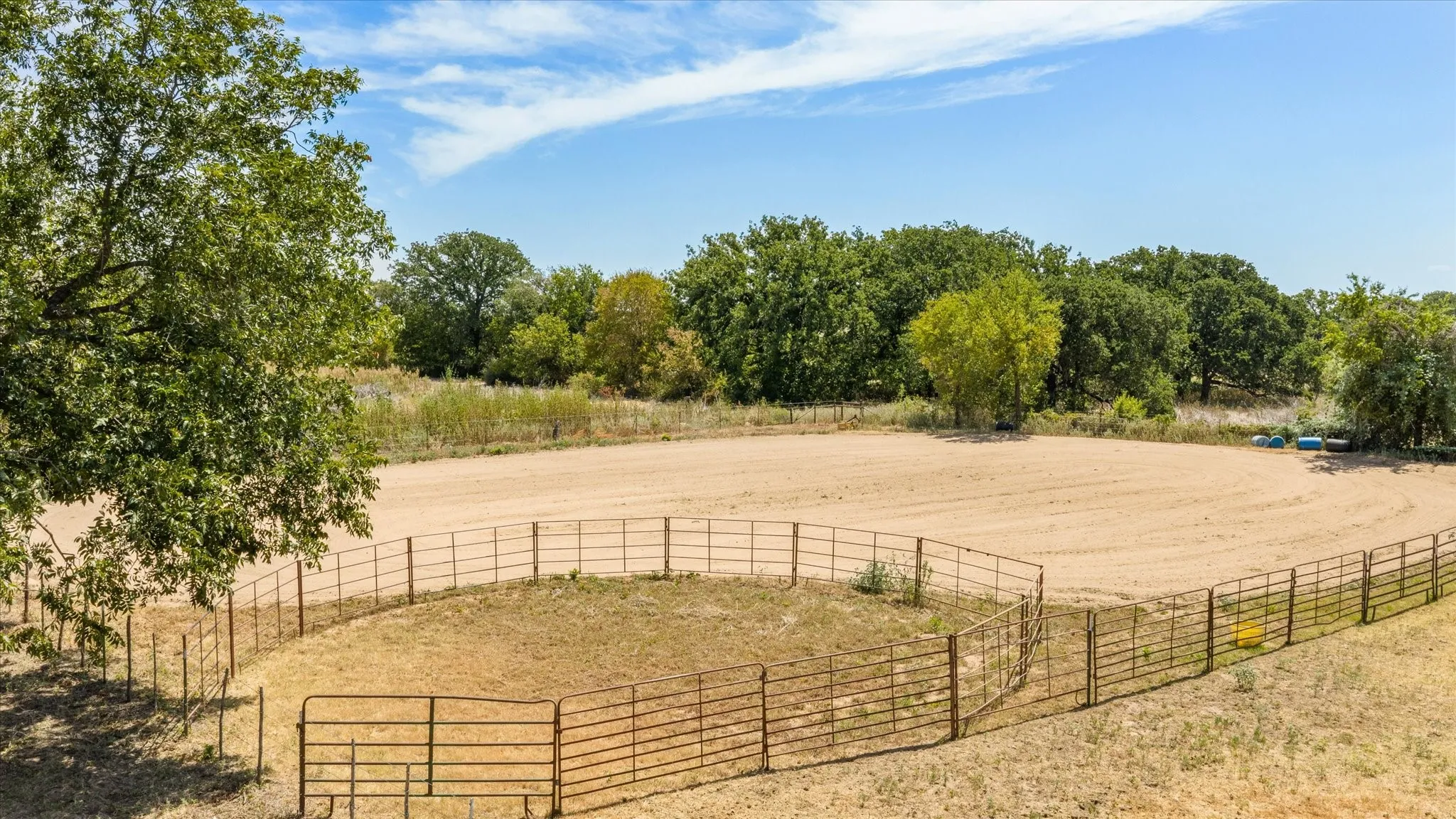 Expansive outdoor arena area with a sandy surface and perimeter fencing is negotiable