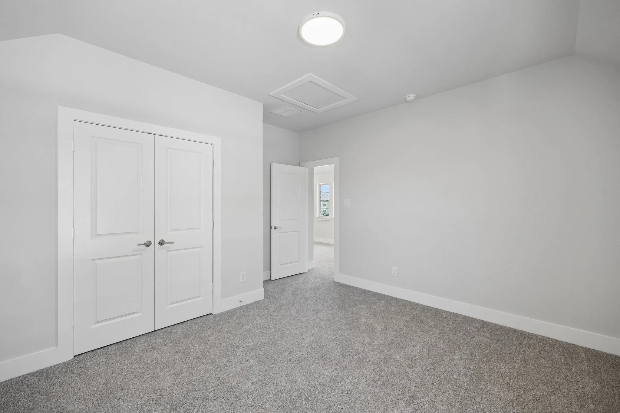 Neutral-toned walls and grey carpeting
