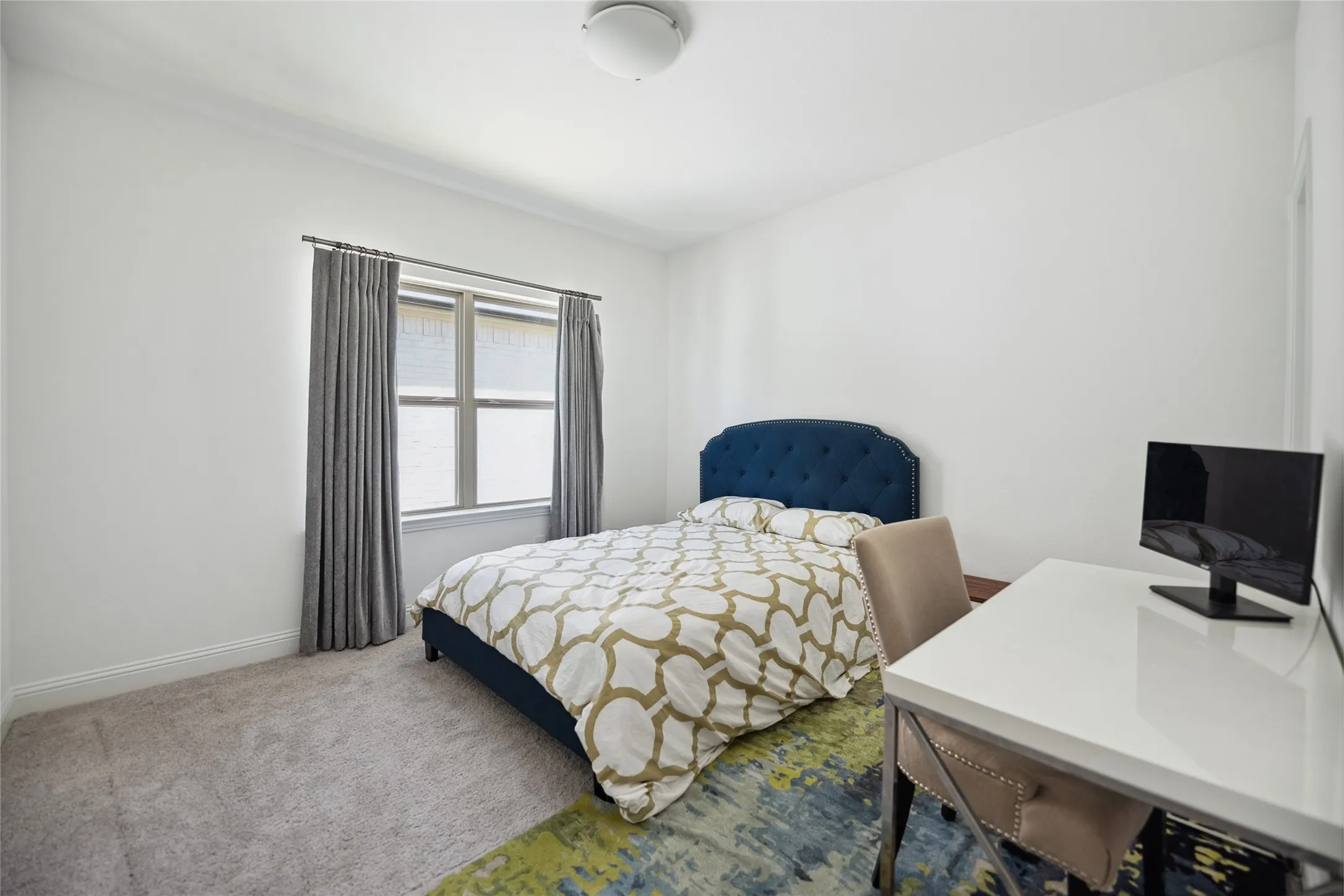 Wall-to-wall carpeting with a low pile, white walls, and a multi-pane window with interior blinds