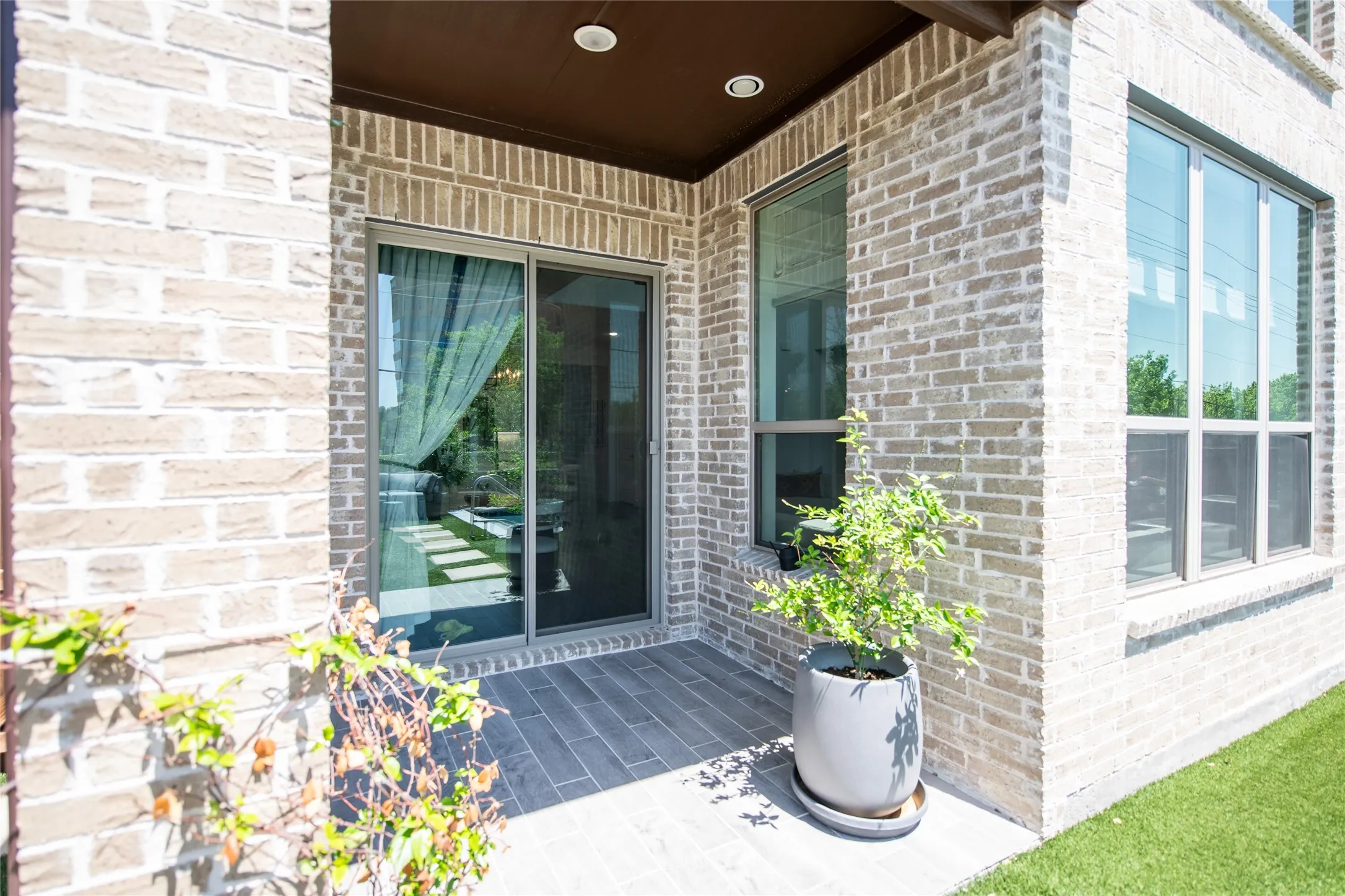Brick exterior with multiple windows and a sliding glass door