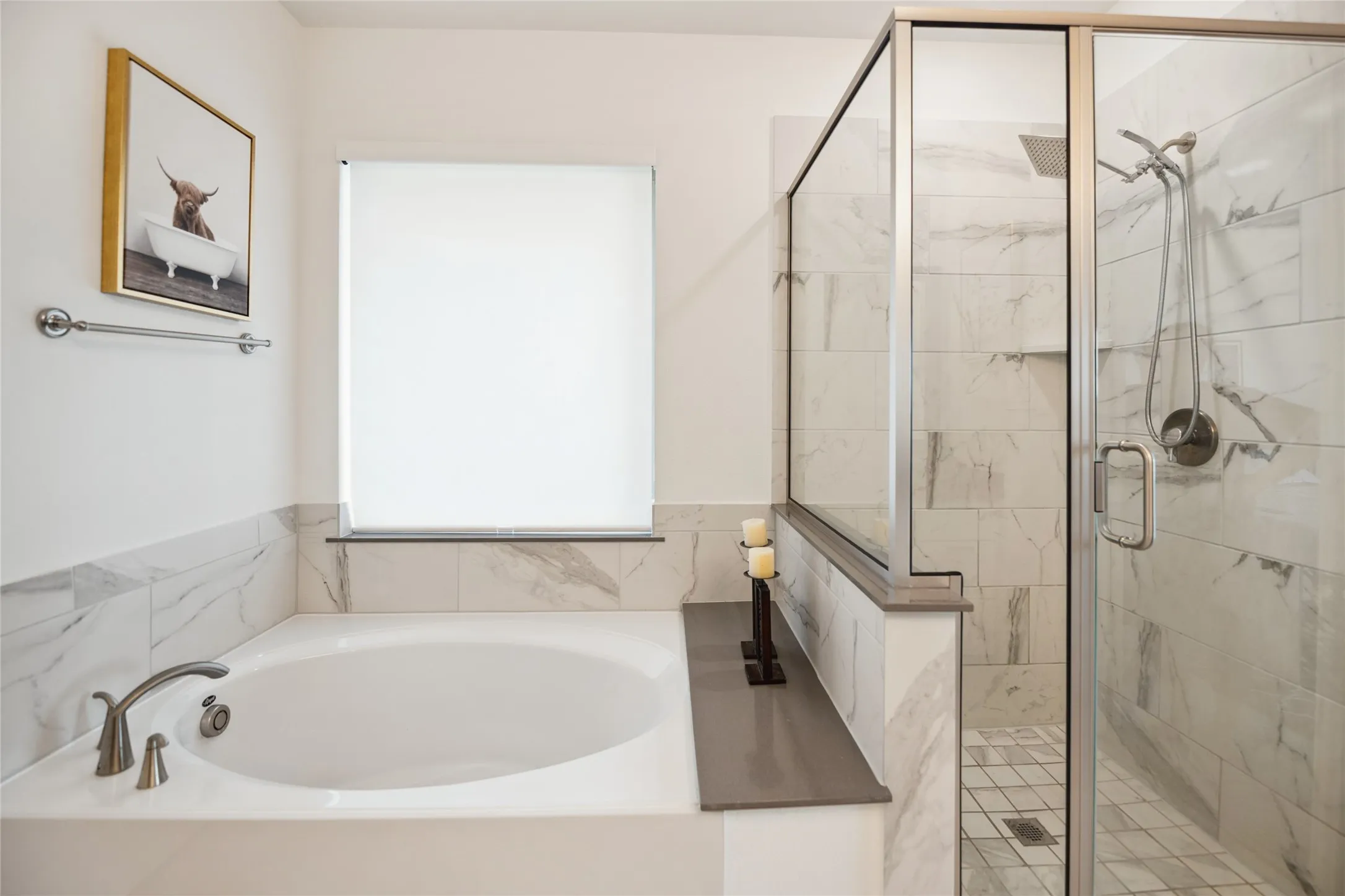Built-in soaking tub with brushed nickel fixtures, separate glass-enclosed shower with tiled walls and flooring, and a large window with roller shade