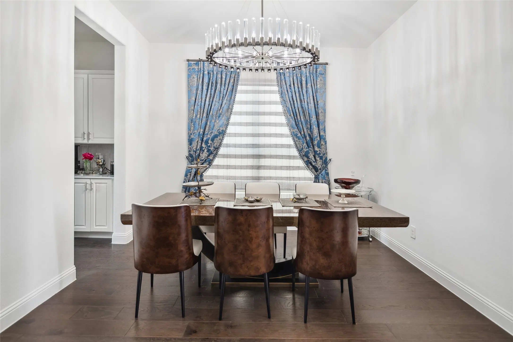 Dark wood-finish flooring with white baseboards