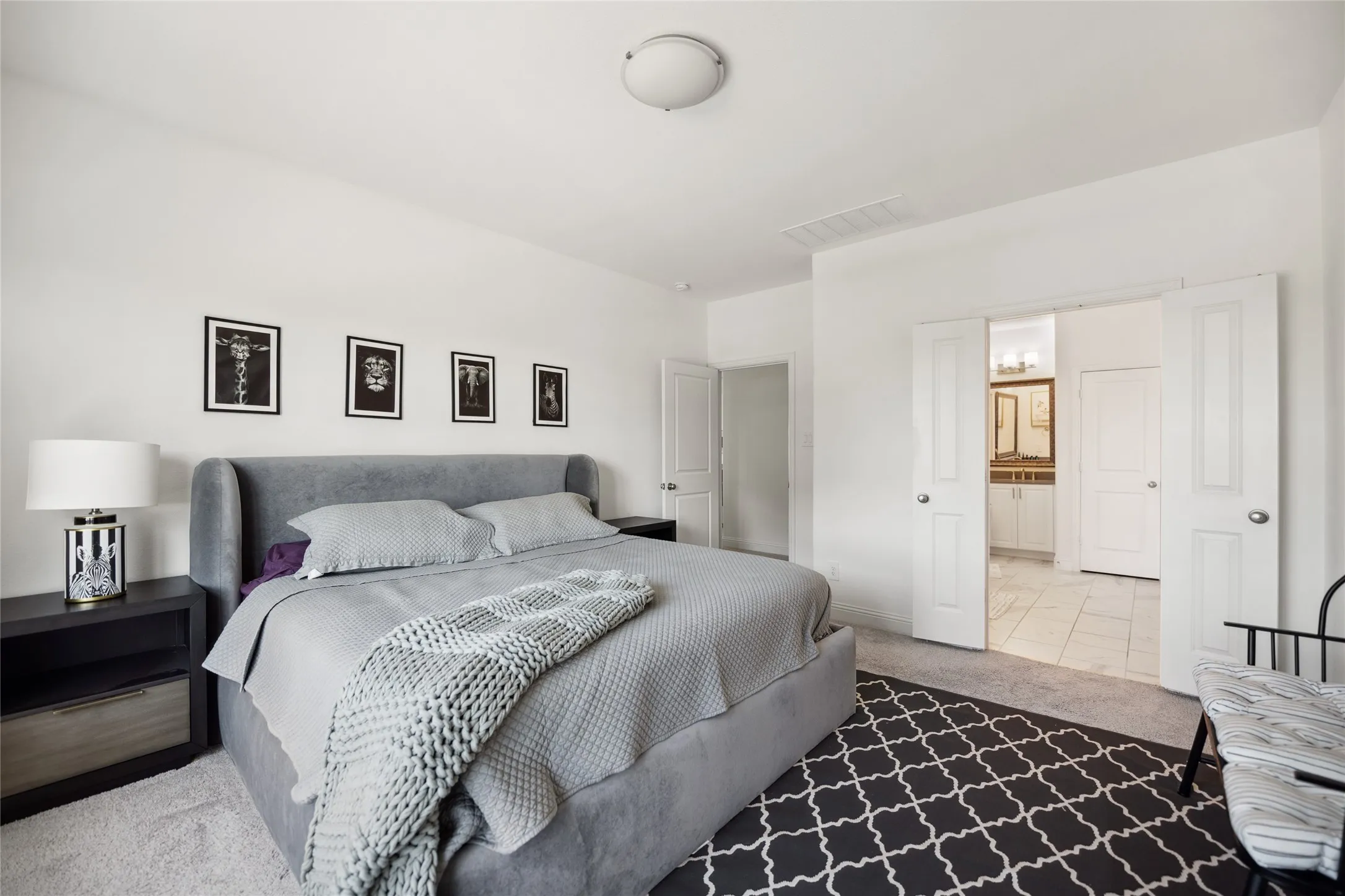 Recessed lighting, light-colored carpeting, white interior doors, and tile flooring visible in the distance