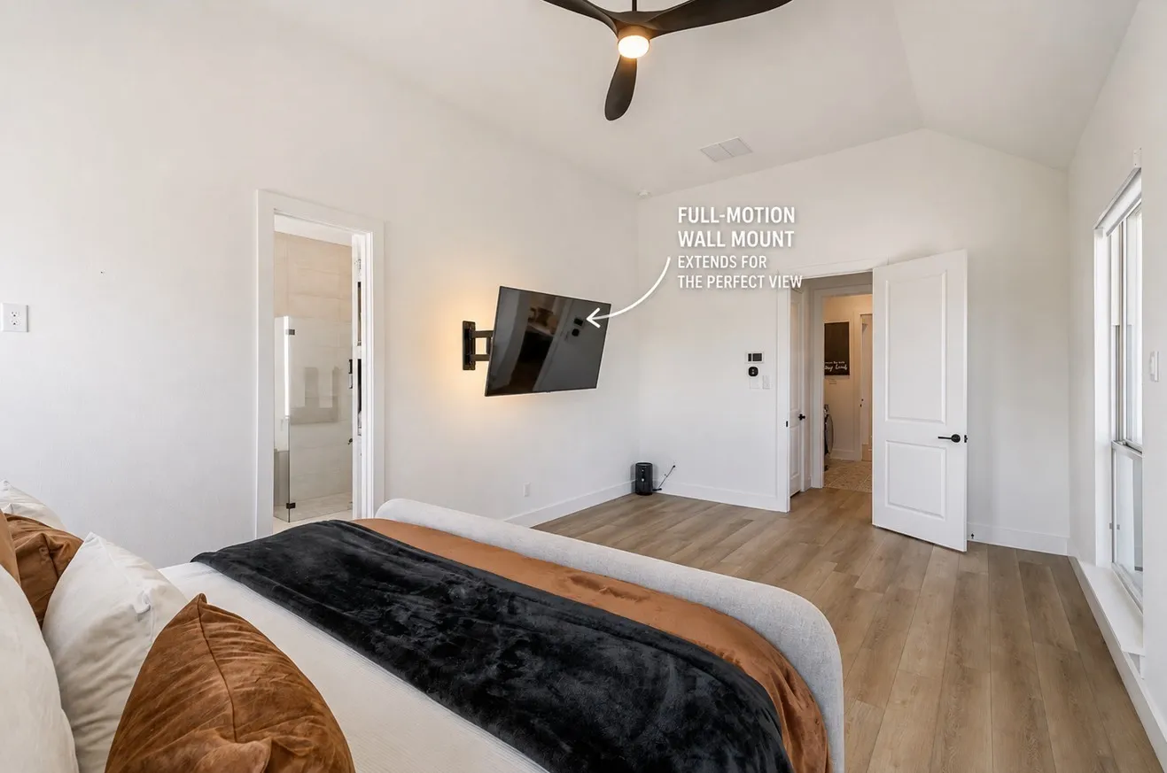 Vaulted ceiling with a ceiling fan, wood-finish flooring, white walls, and a wall-mounted television