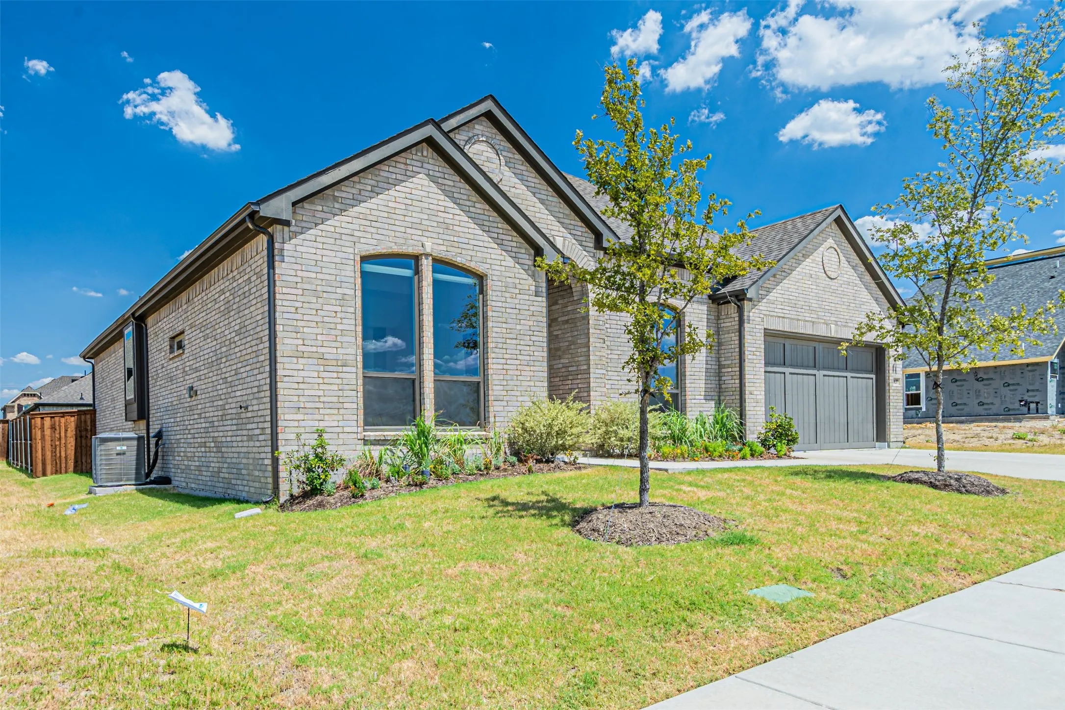 Brick exterior with dark trim and an arched window
