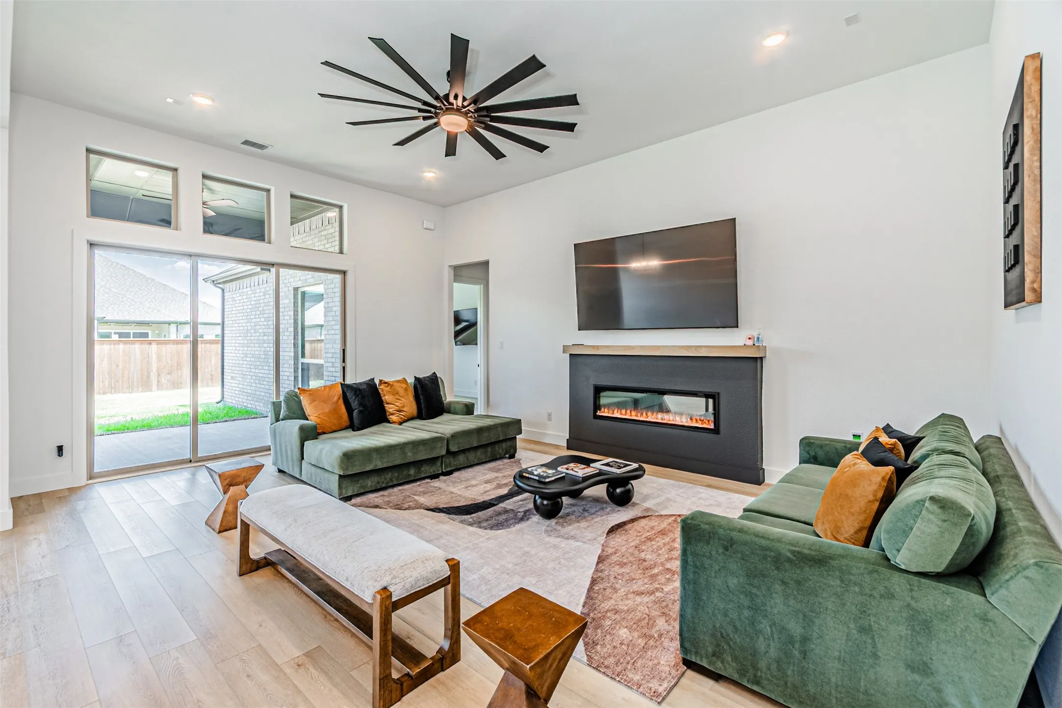 High ceilings with recessed lighting, wood-finish flooring, and a modern ceiling fan