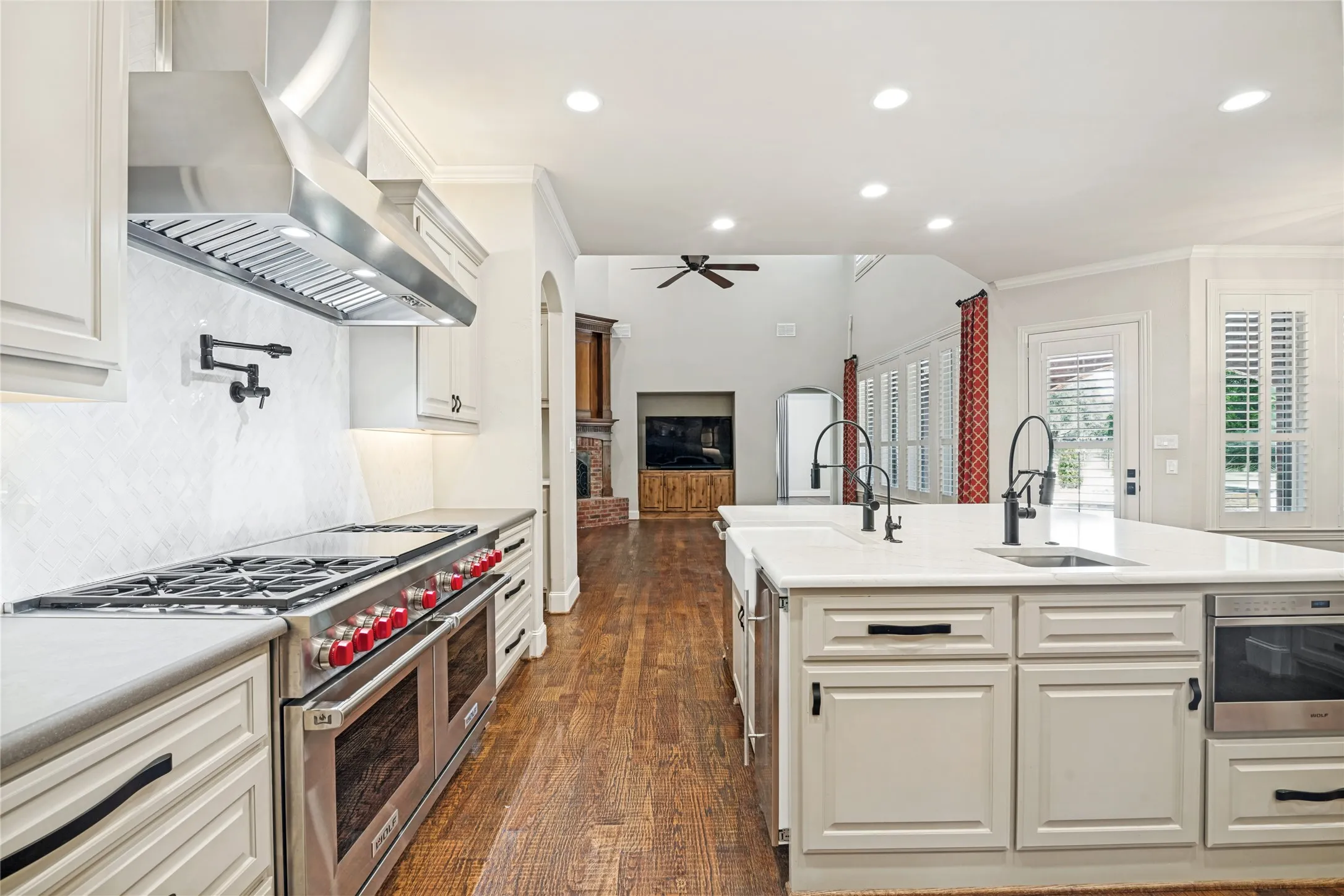 Gourmet kitchen with professional-grade stainless steel range, custom range hood, and pot filler