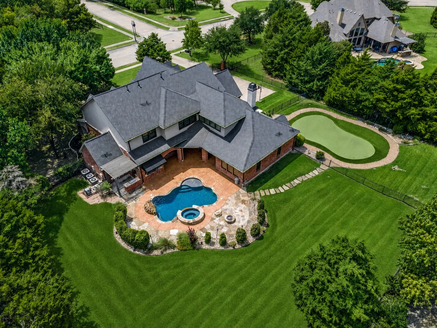 Brick and stucco exterior with a multi-level shingle roof