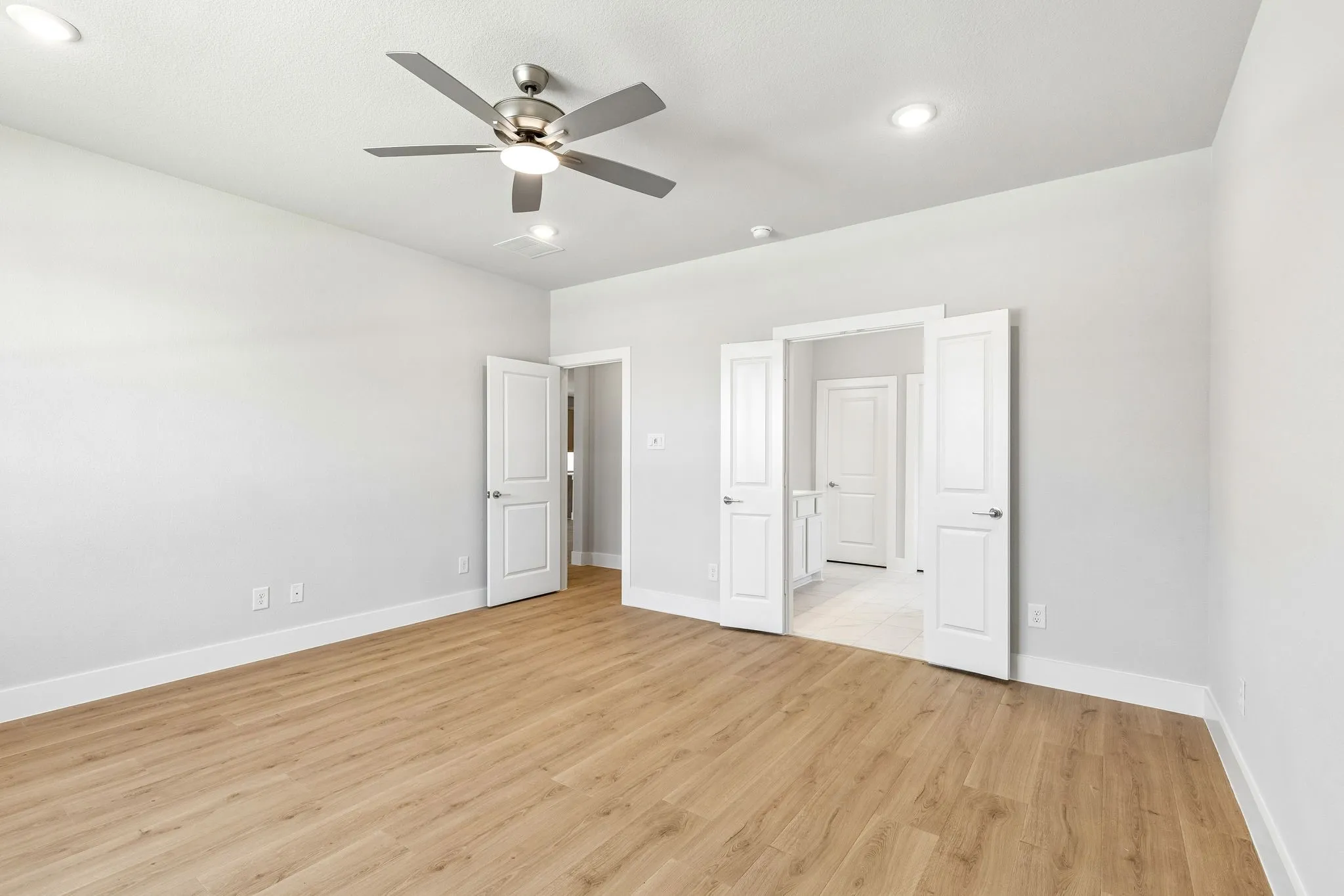 Wood-finish flooring with white baseboards
